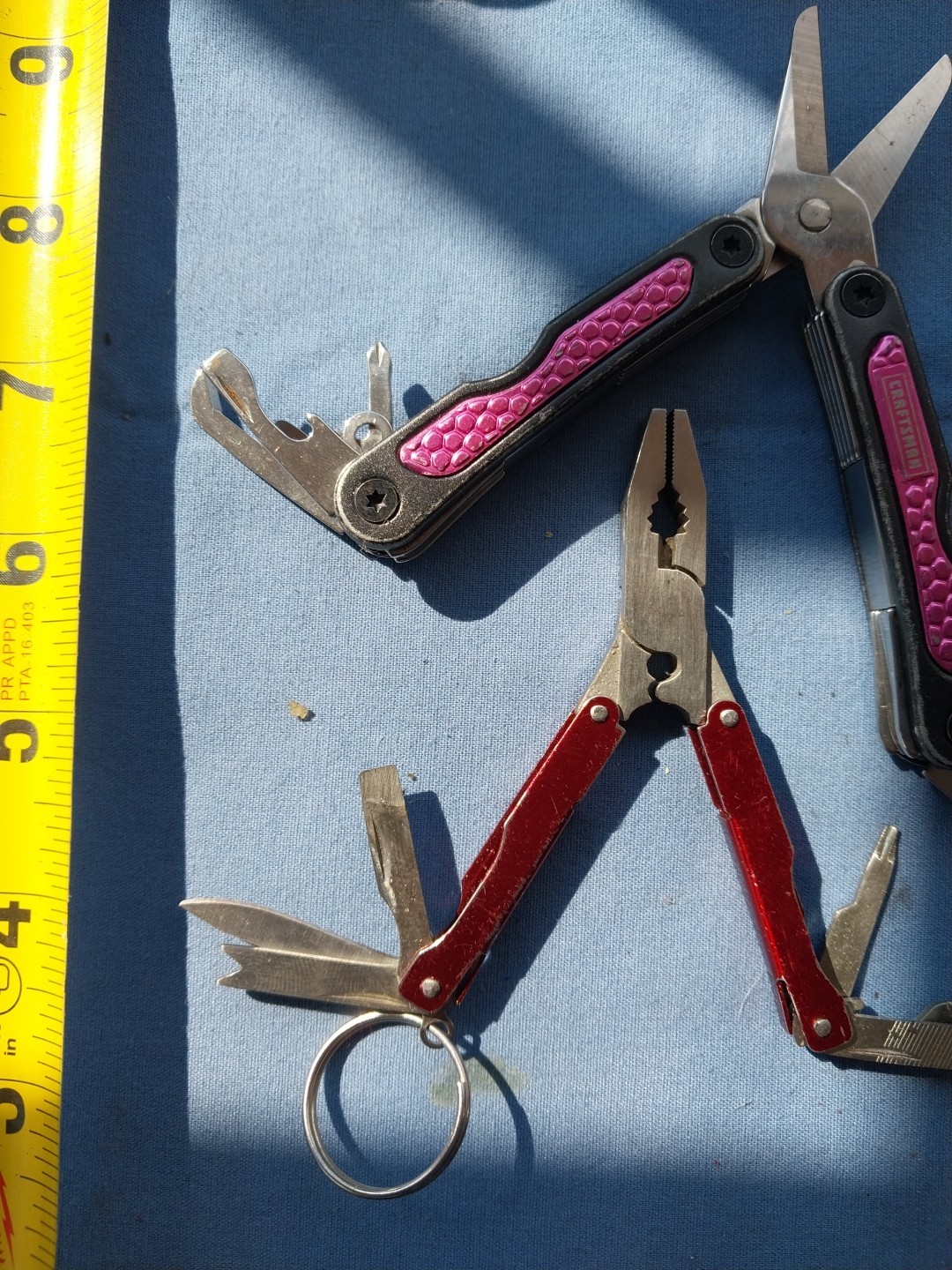 4 multi tools with pliers knives screwdrivers saw
