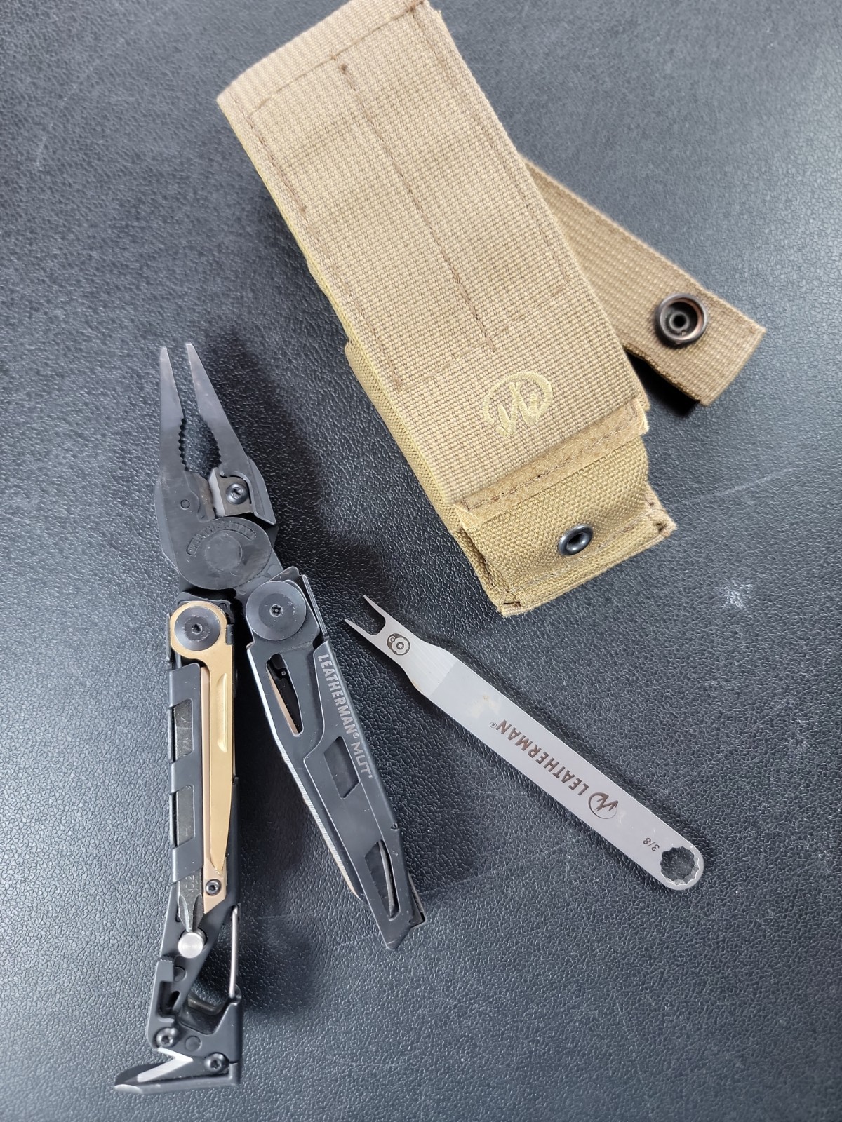 Leatherman MUT Black multi tool with Brown/Tan Inserts.