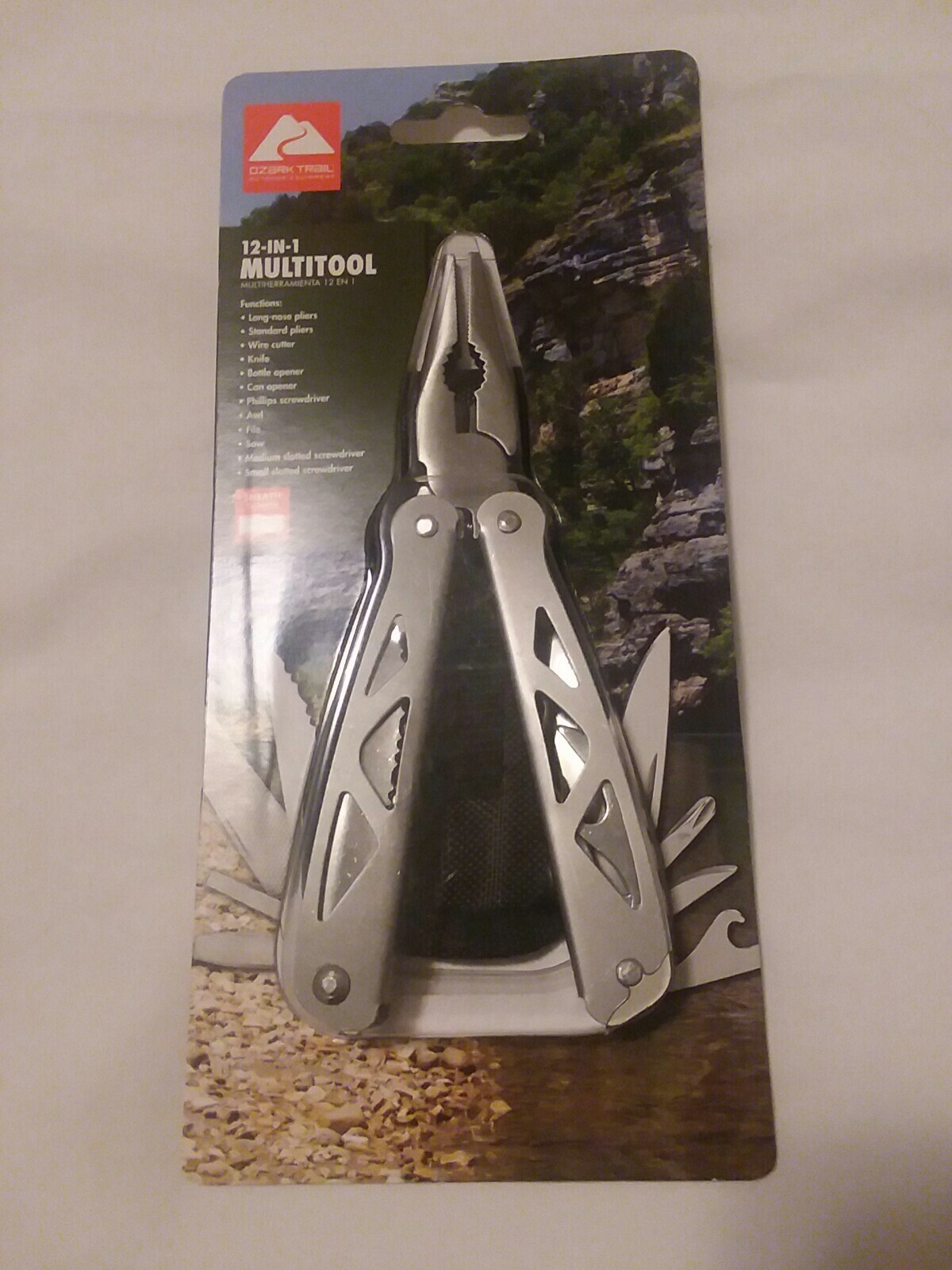 Ozark Trail 12-in-1 Multi Tool with Nylon Black Sheath. Silver handle.