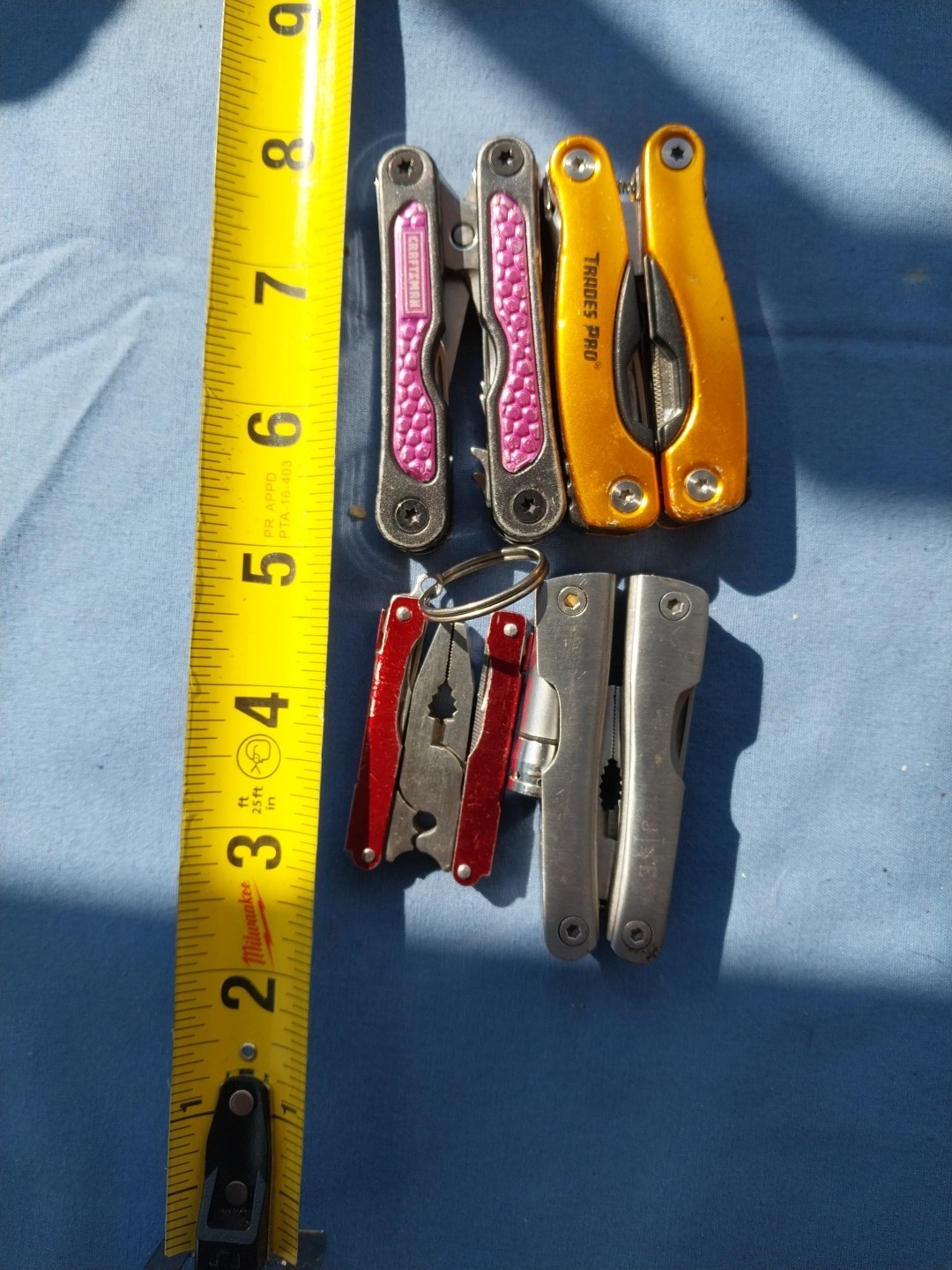 4 multi tools with pliers knives screwdrivers saw