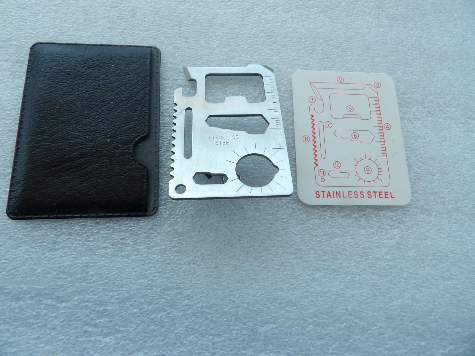 Wallet-sized stainless steel multi-tool with 11 different functional features
