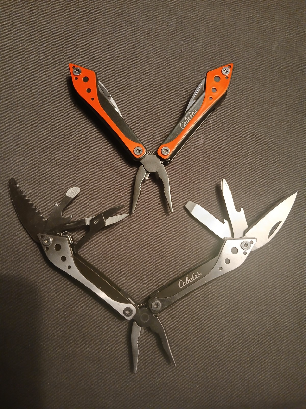 Lot 0f 2 Cabela’s Multi-Tool 1) Silver /1) Orange Unused with Cases