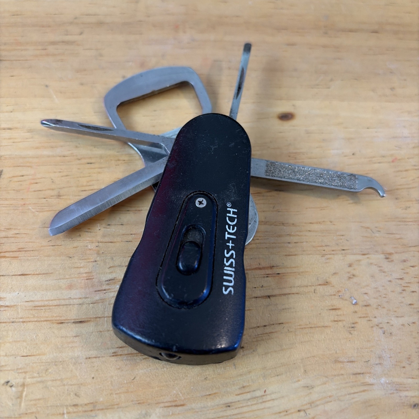 Swiss+Tech Swivel Tool 8-in-1 bottle opener multi tool with light