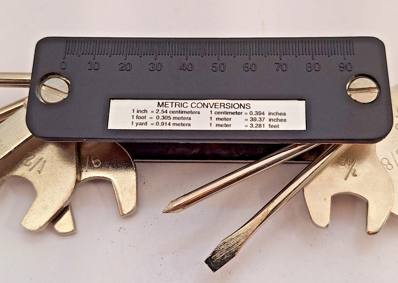 Unbranded Multitool with pouch, wrenches, screwdivers, metric chart and more.