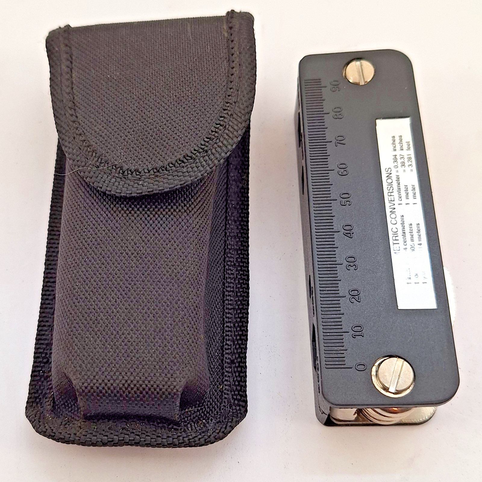 Unbranded Multitool with pouch, wrenches, screwdivers, metric chart and more.