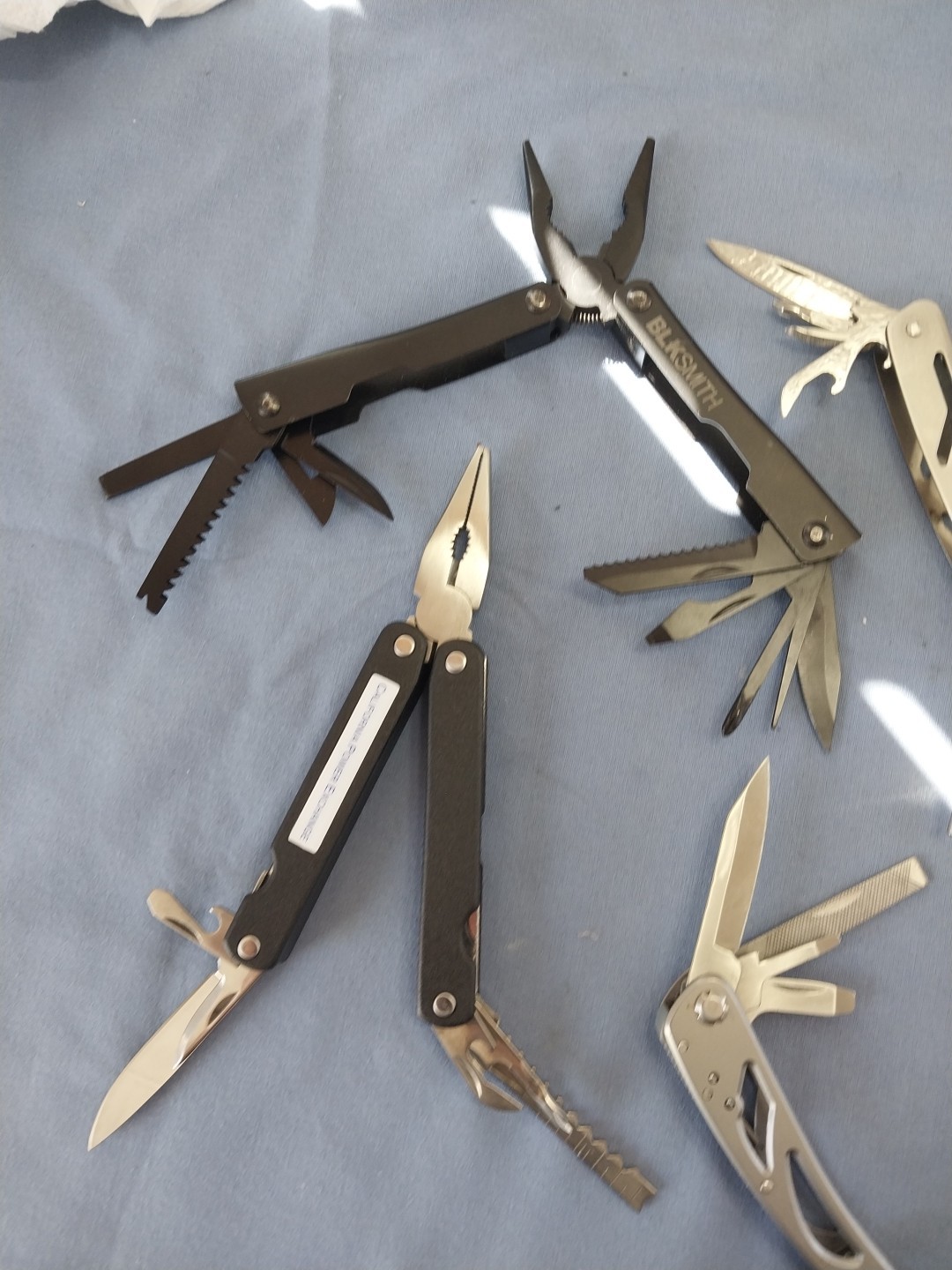 4 multi tools pliers screwdriver knife saw