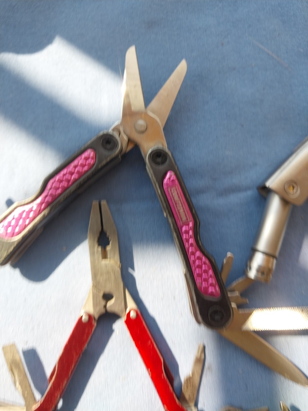 4 multi tools with pliers knives screwdrivers saw