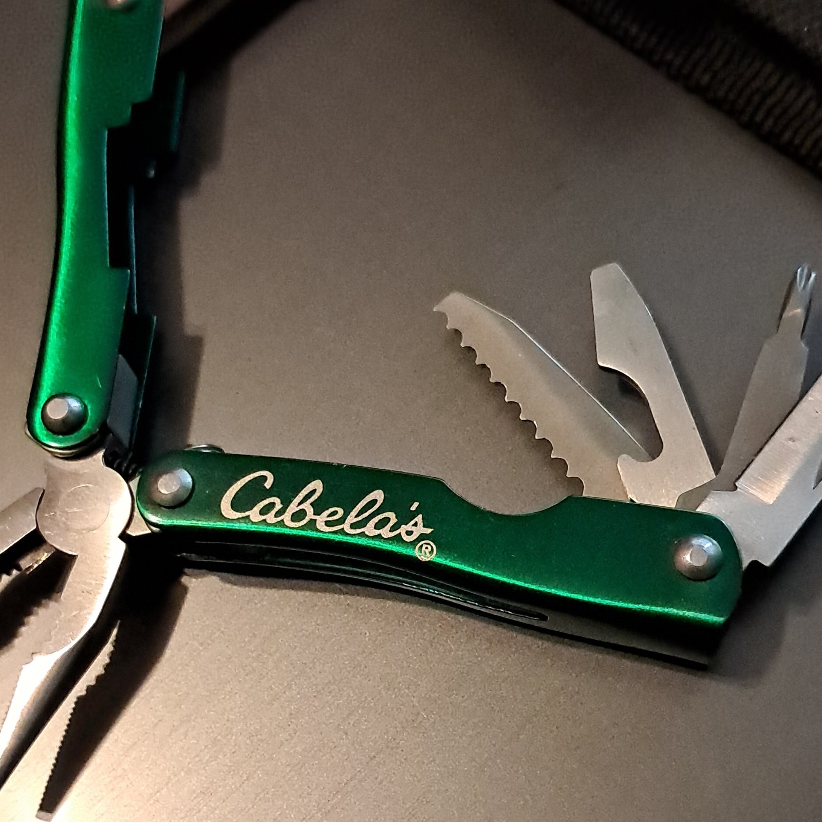 Cabela’s Green/Silver 6-in-1 Multi-Tool Pliers, 2.25″ SS Blade w/ Sheath