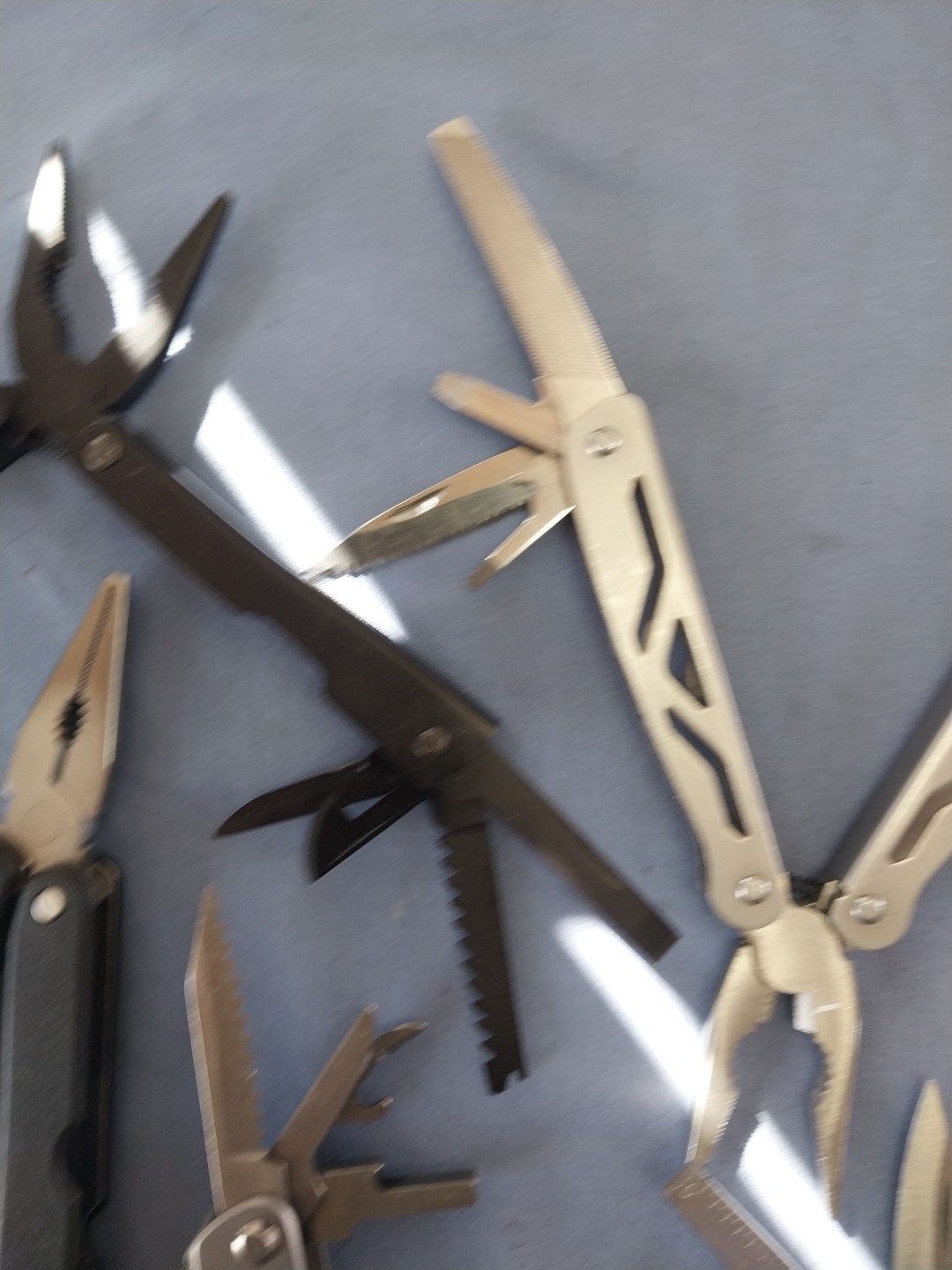 4 multi tools pliers screwdriver knife saw