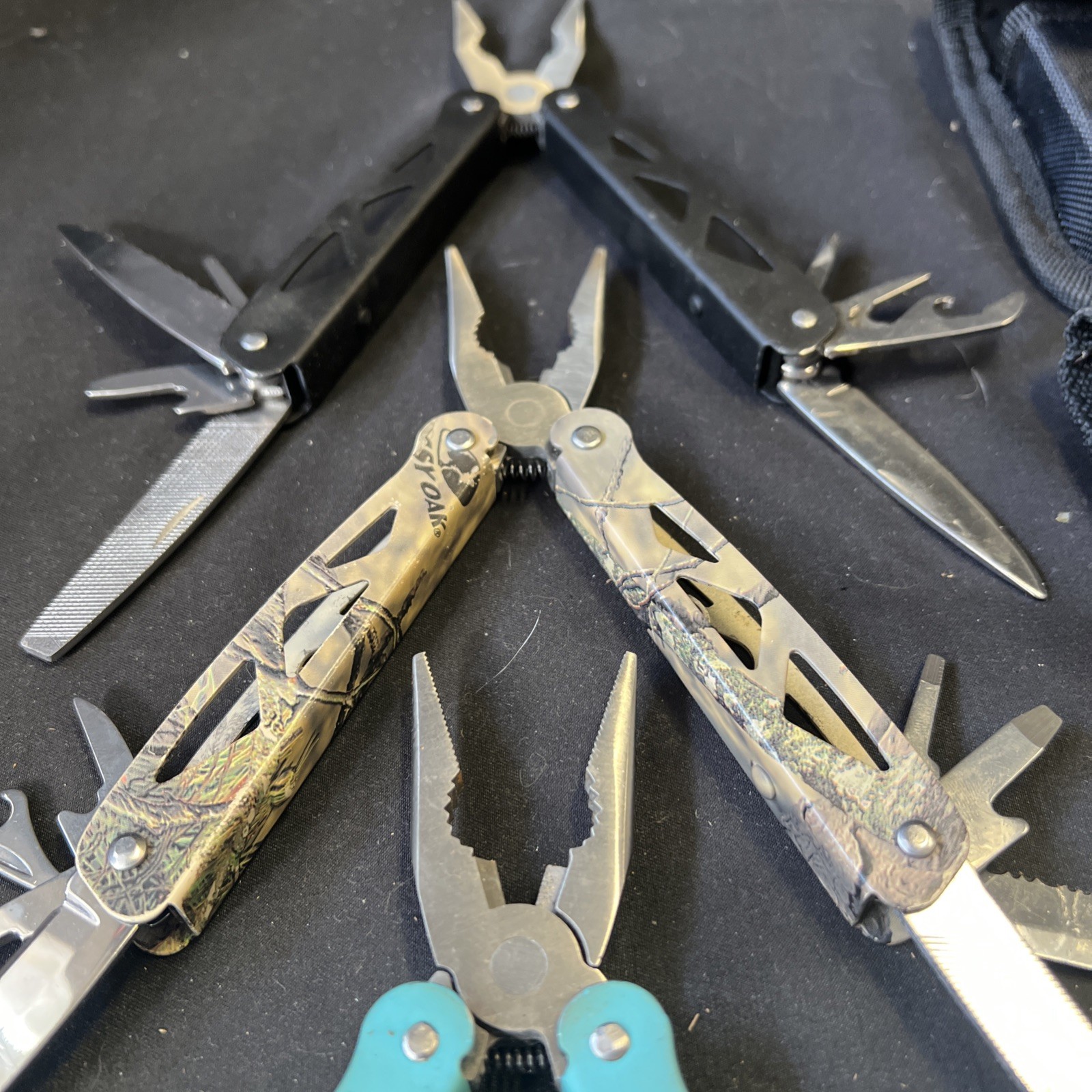Set Of 3 Ozark Trail Trailside 12-in-1 Multitool – Black, Teal, & Camouflage