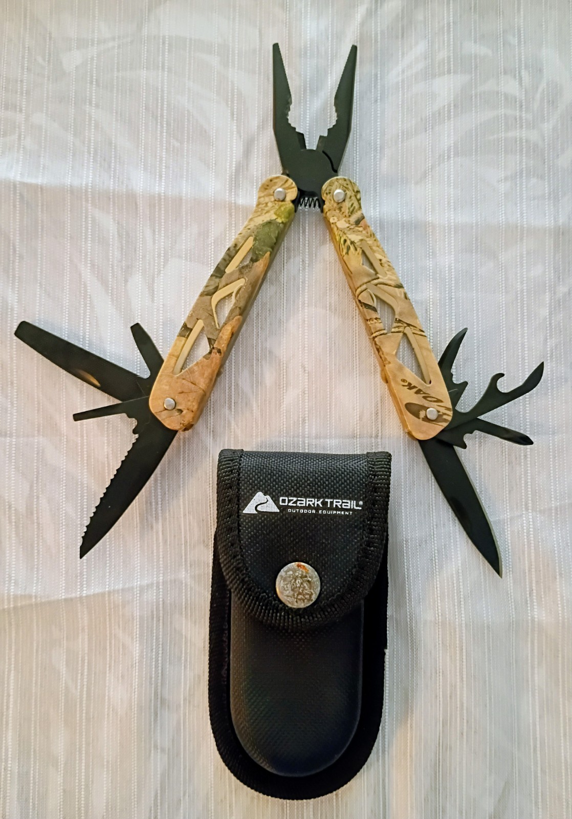 Ozark Trail… Multi tool, with sheath. Camouflage pattern, black colored tools.