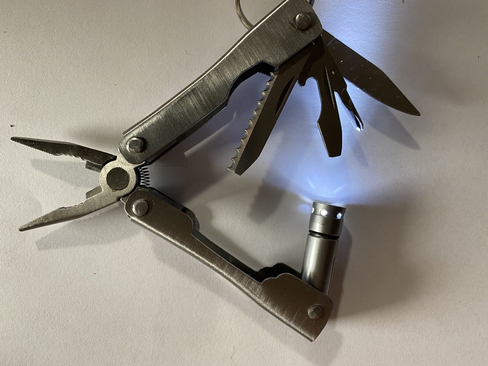 Lot of 2 Multitools w/ pliers blade file saw flash light scissors etc.