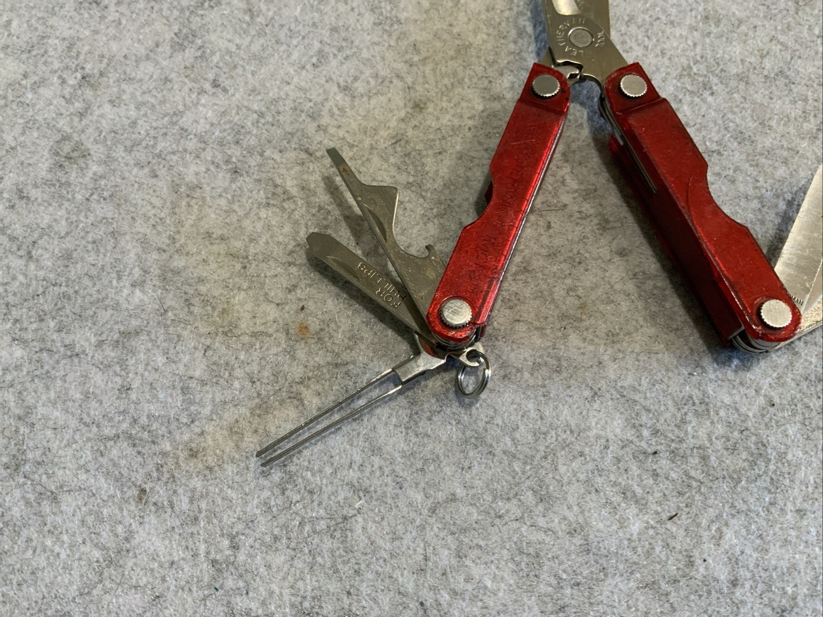 Leatherman Micra Multi Tool Red Transparent Plastic Coating Chipped