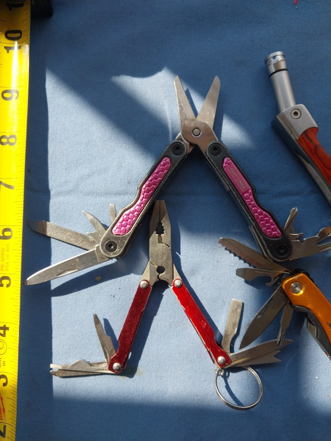 4 multi tools with pliers knives screwdrivers saw