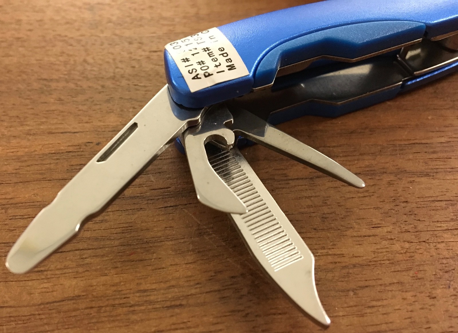 Pair of multi tools, one blue, the other black, with sheaths. Camp, hunt, crafts