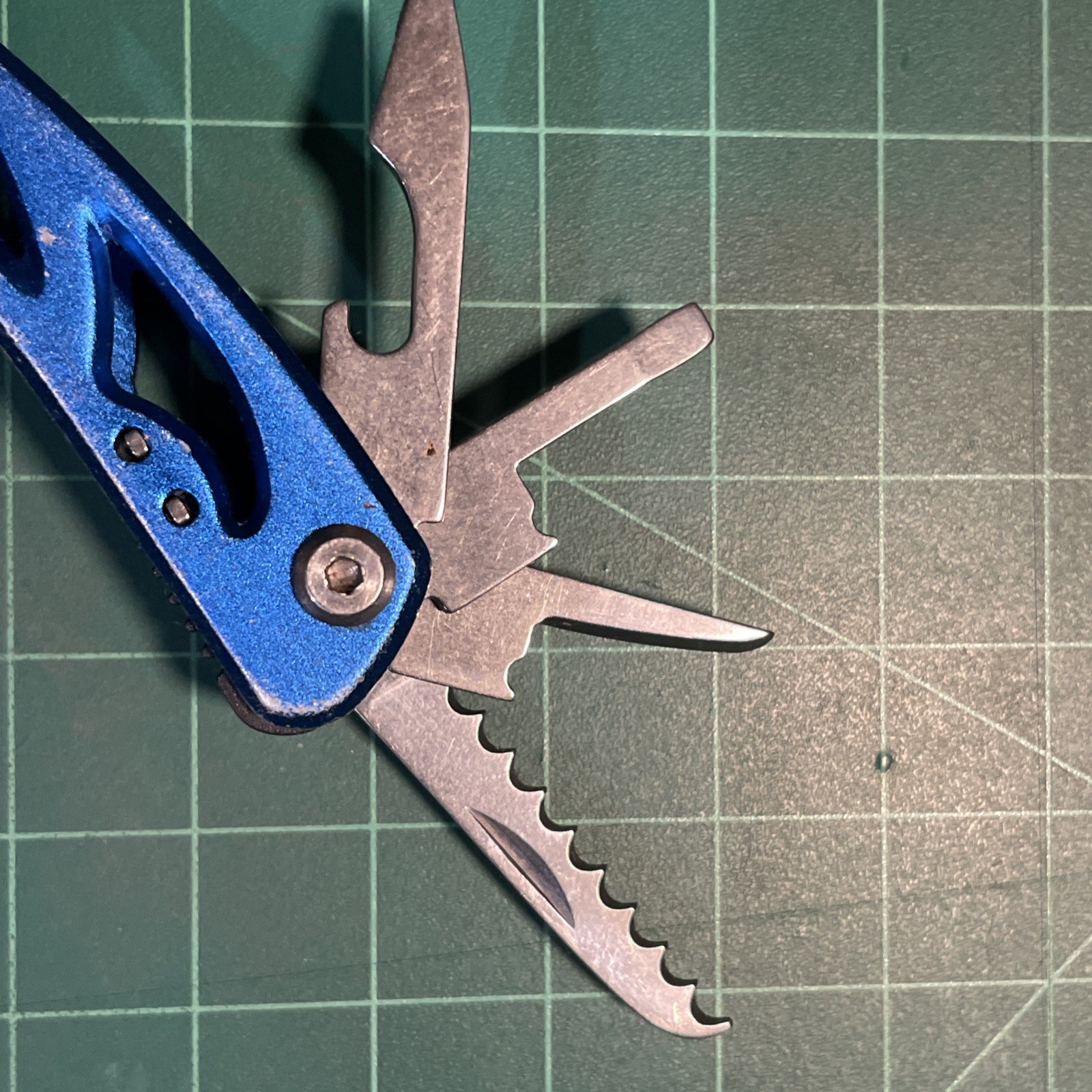 Blue Mini Multi Tool = pliers, knife, wire cutter, screwdrivers, files, etc.