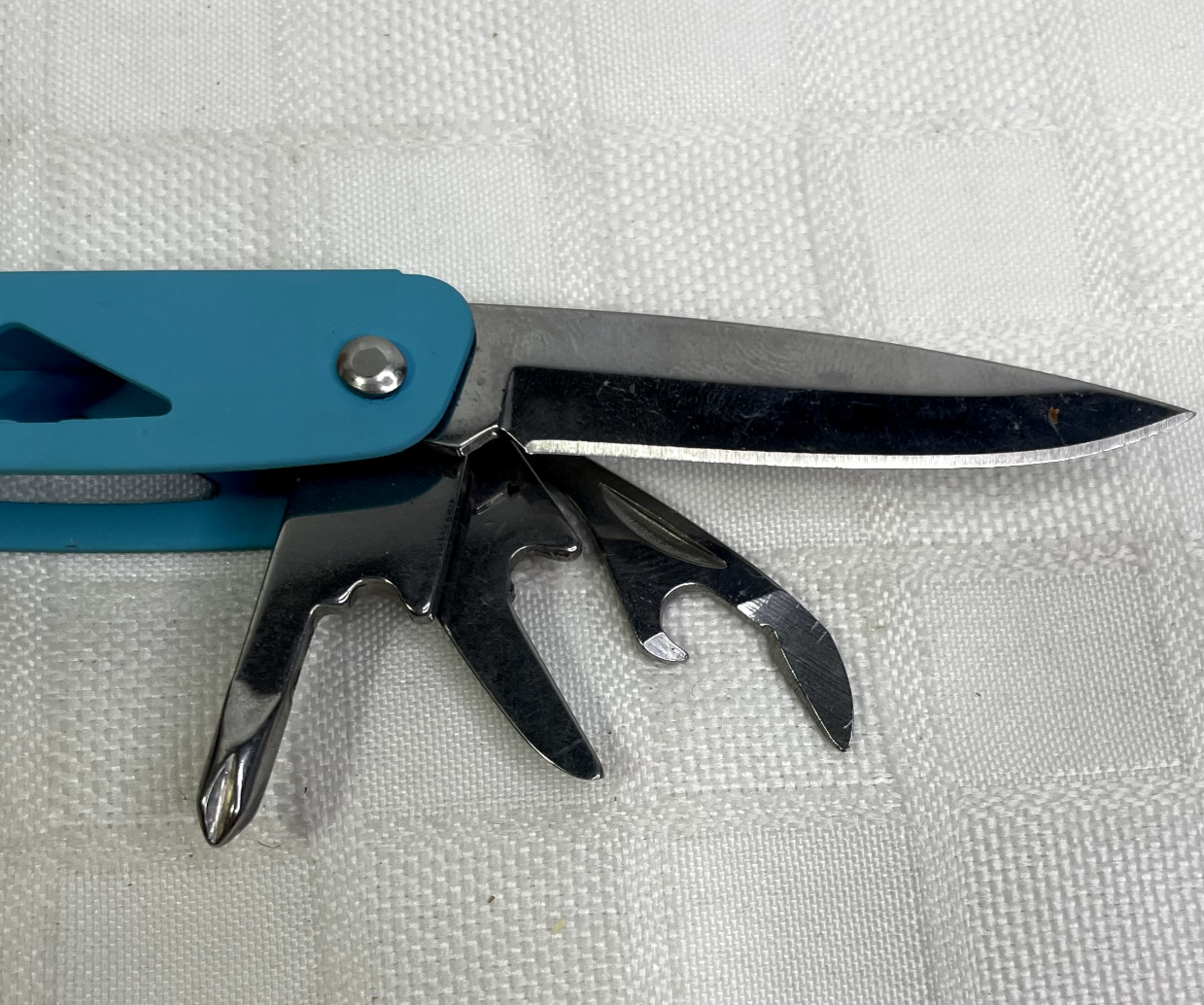 Ozark Trail 12-in-1 Multi Tool with Nylon Black Sheath Teal Blue handle.
