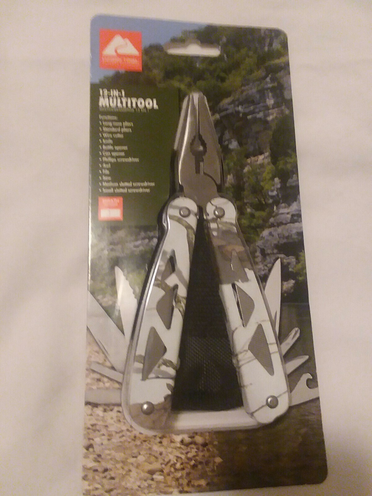 Ozark Trail 12-in-1 Multi Tool with Nylon Black Sheath. White camo handle.