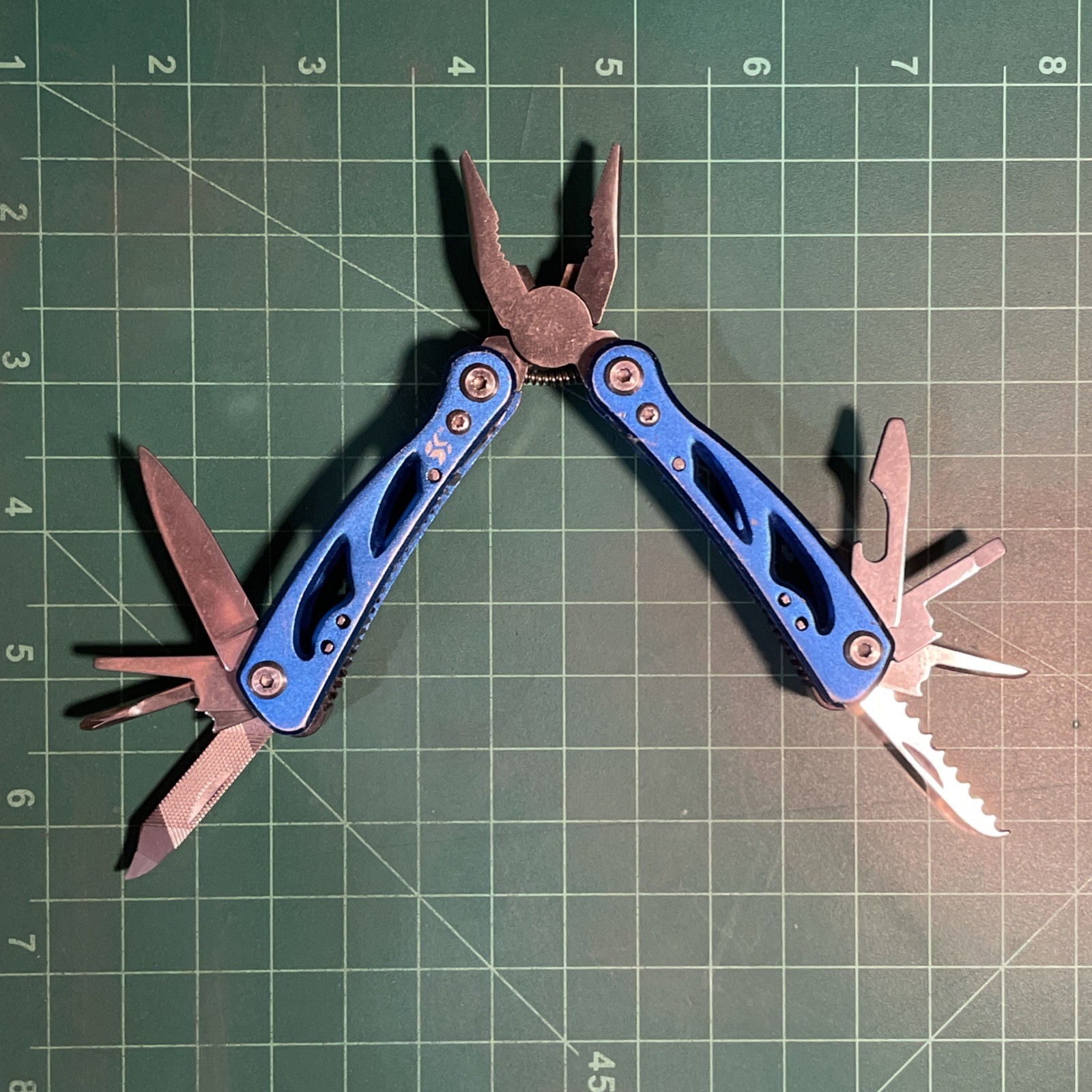 Blue Mini Multi Tool = pliers, knife, wire cutter, screwdrivers, files, etc.