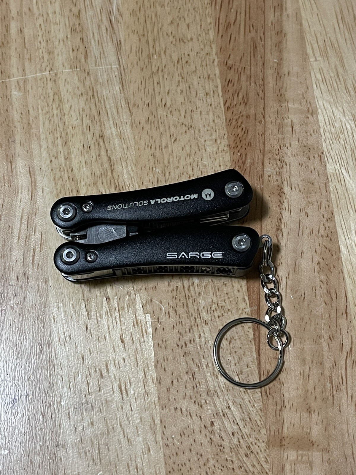 Sarge Mini 10 In 1 Black Zytel Stainless Steel Multi Tool Company Logo