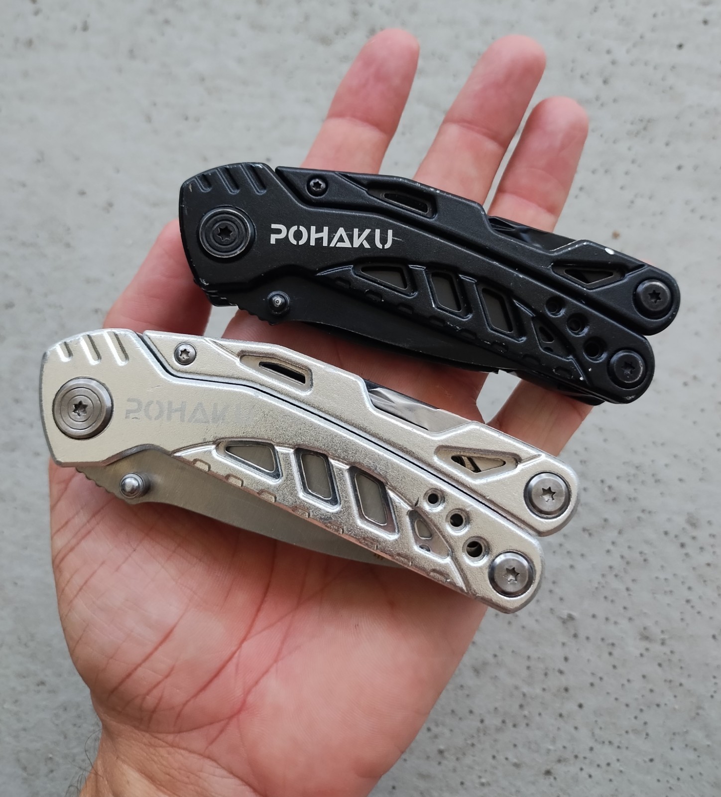 POHAKU BLACK & SILVER MULTI TOOL PLIERS KNIFE, SAW BLADE, FILE, ETC. LOT OF 2