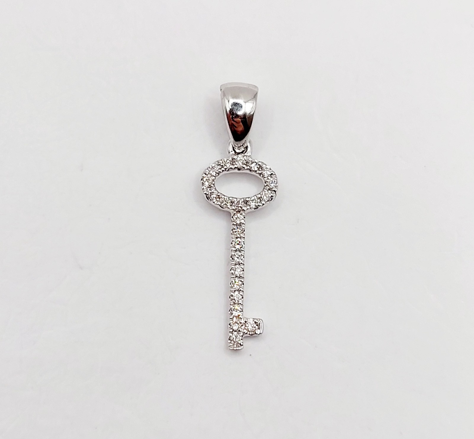 Vintage 18k white gold key pendant pavé-set with diamonds