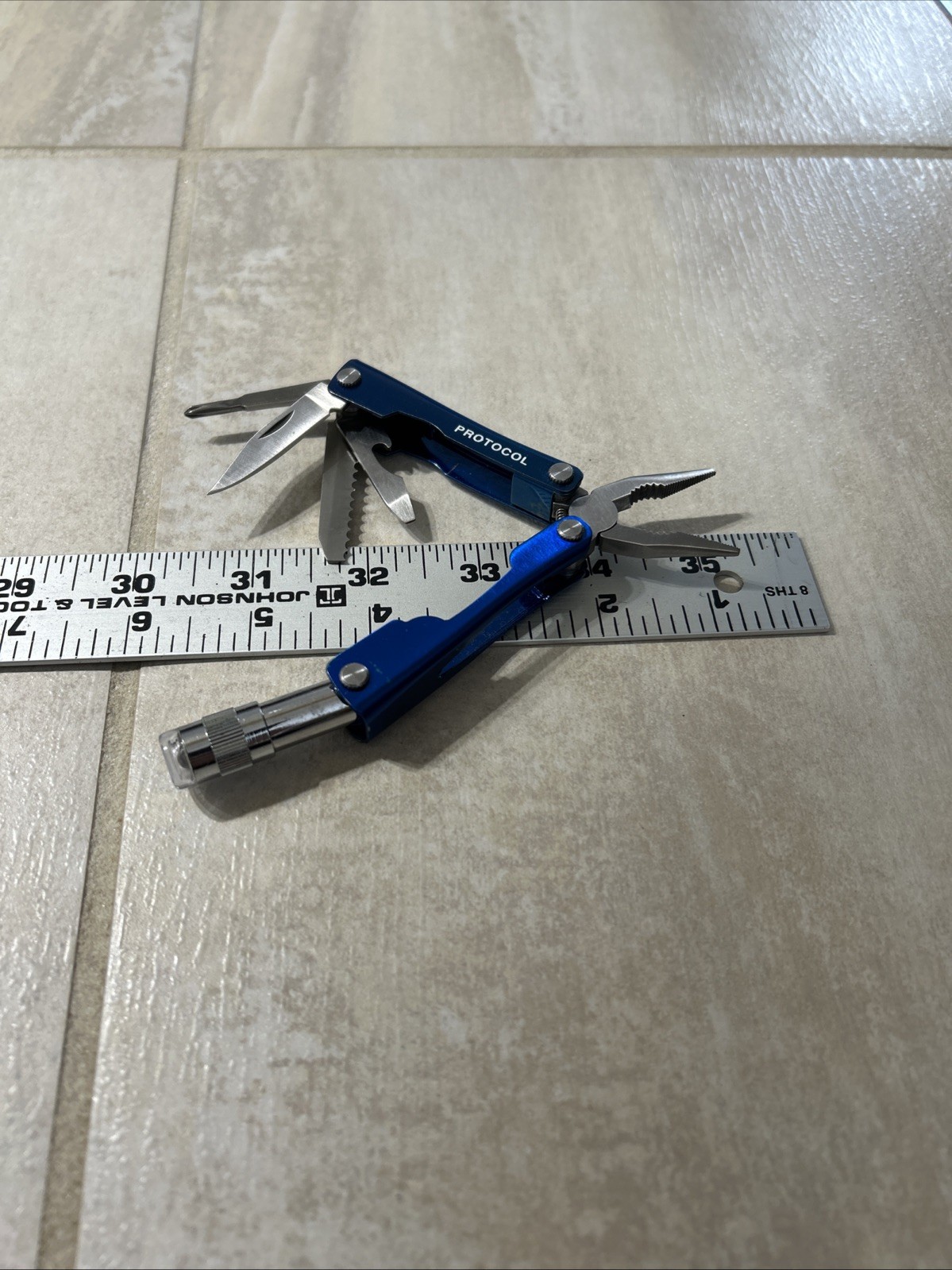 PROTOCOL 8 FUNCTION MINI MULTI TOOL WITH SHEATH – Pliers, Flashlight, Etc.