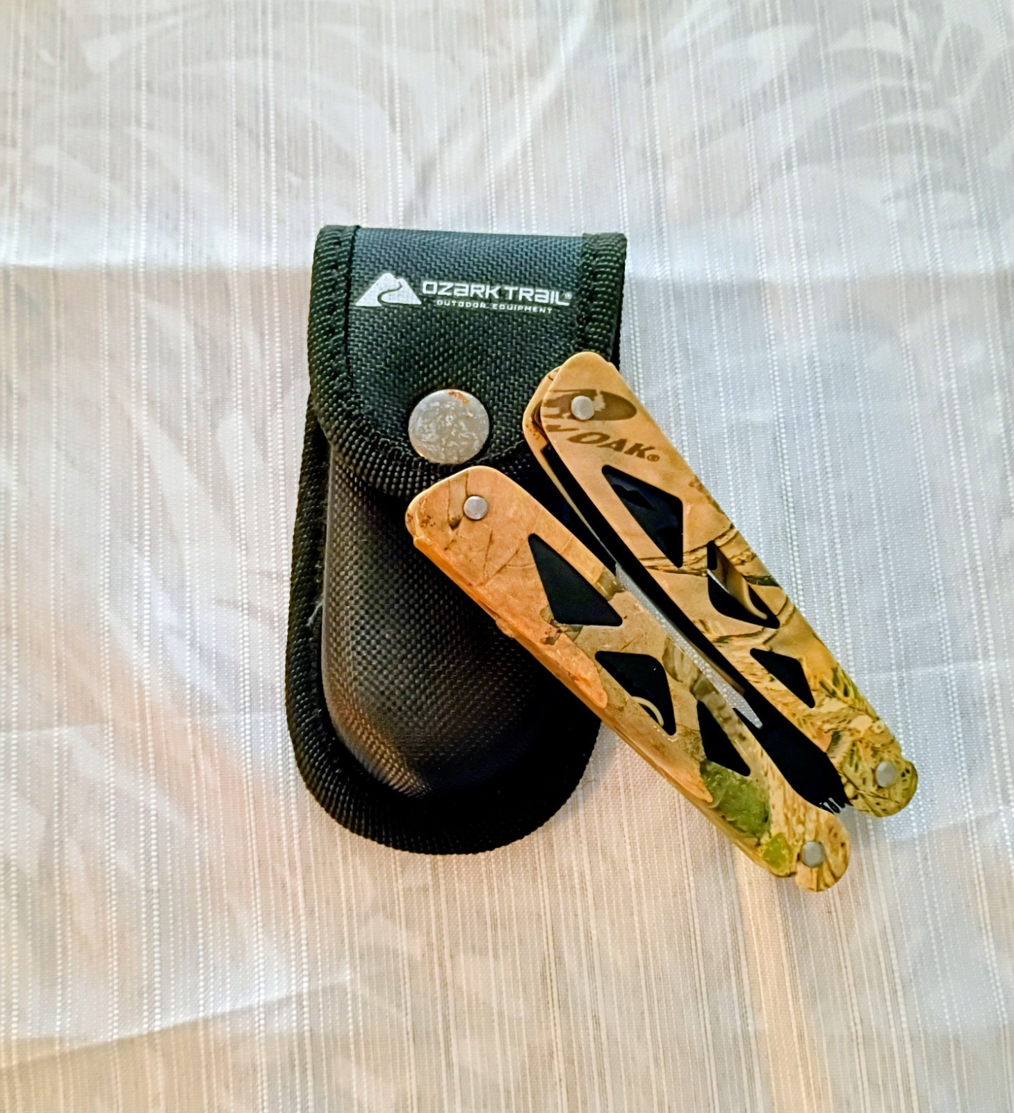 Ozark Trail… Multi tool, with sheath. Camouflage pattern, black colored tools.