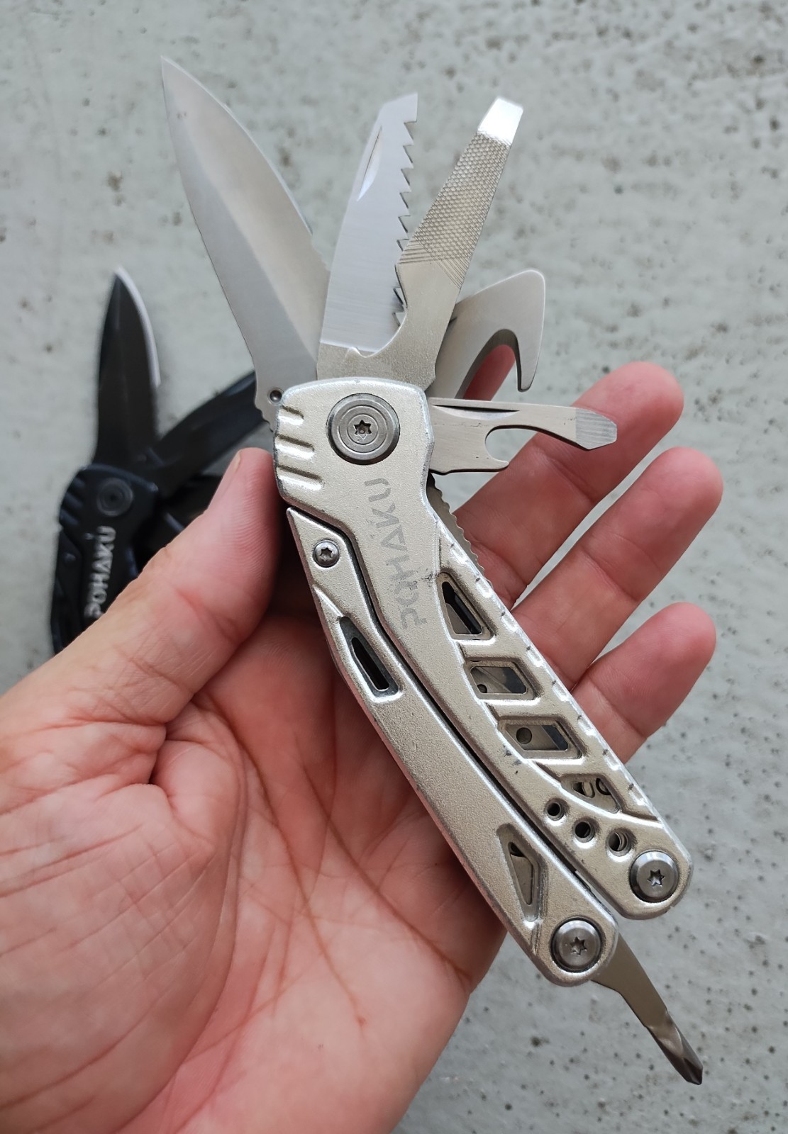 POHAKU BLACK & SILVER MULTI TOOL PLIERS KNIFE, SAW BLADE, FILE, ETC. LOT OF 2