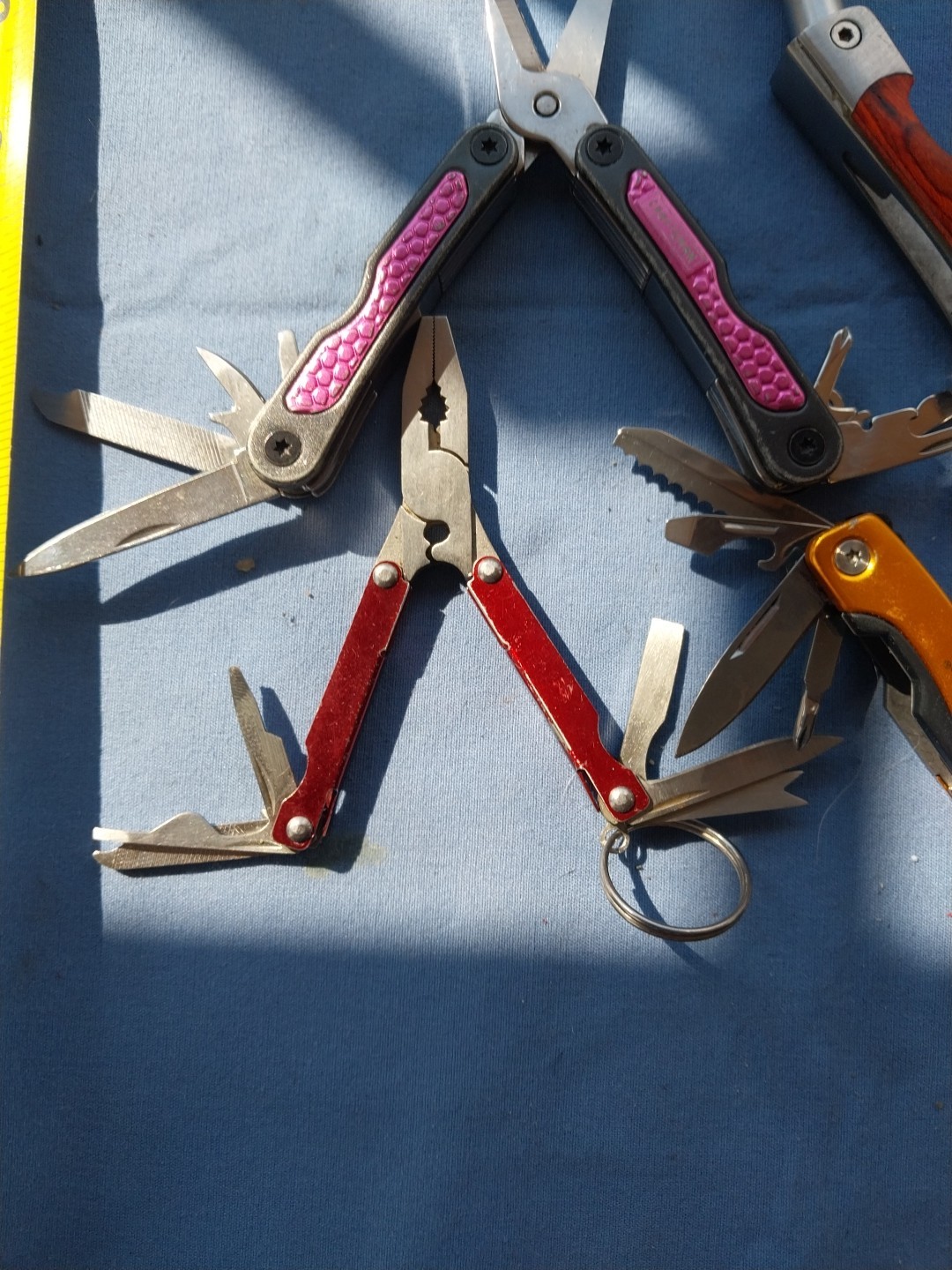 4 multi tools with pliers knives screwdrivers saw