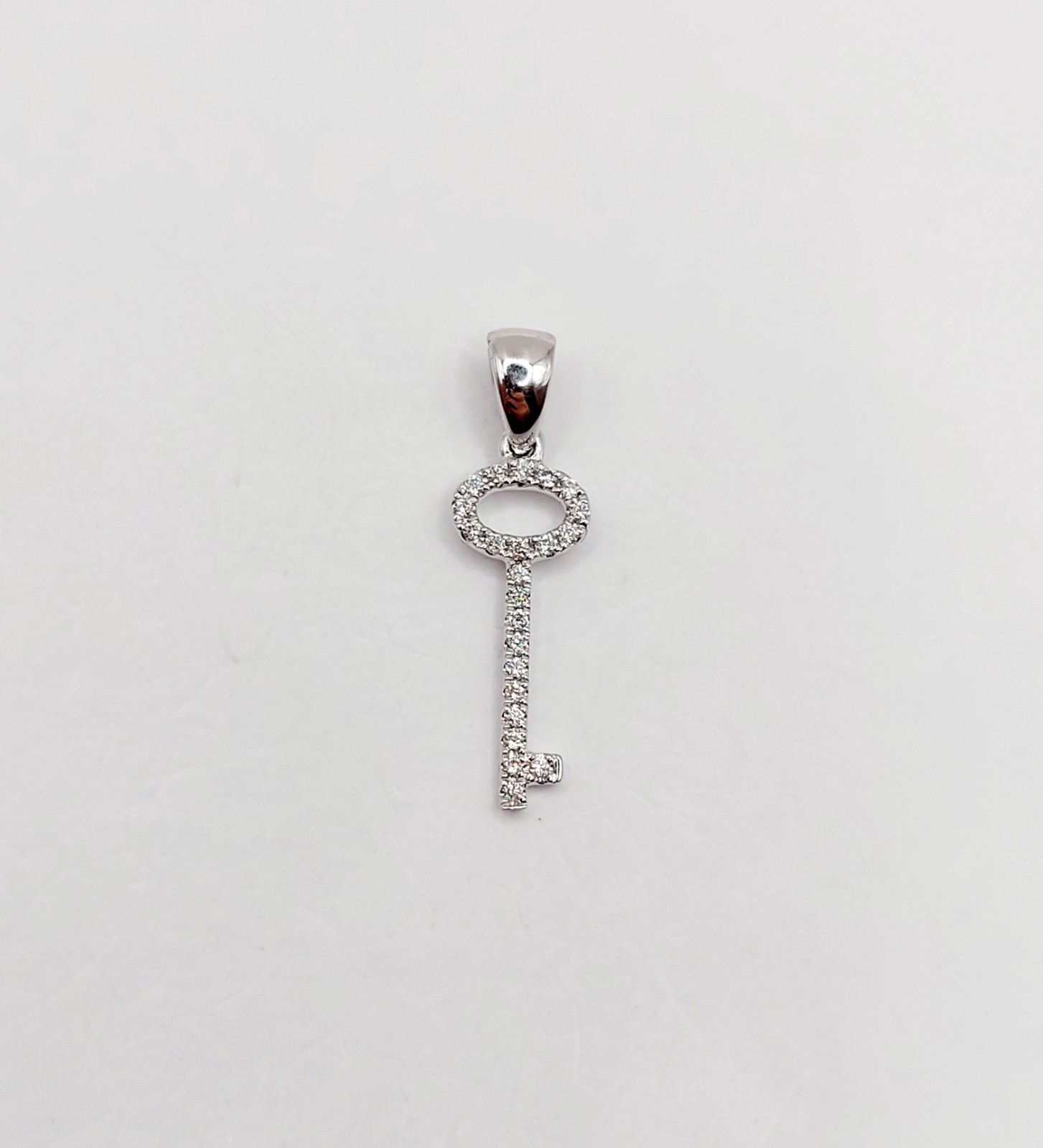 Vintage 18k white gold key pendant pavé-set with diamonds
