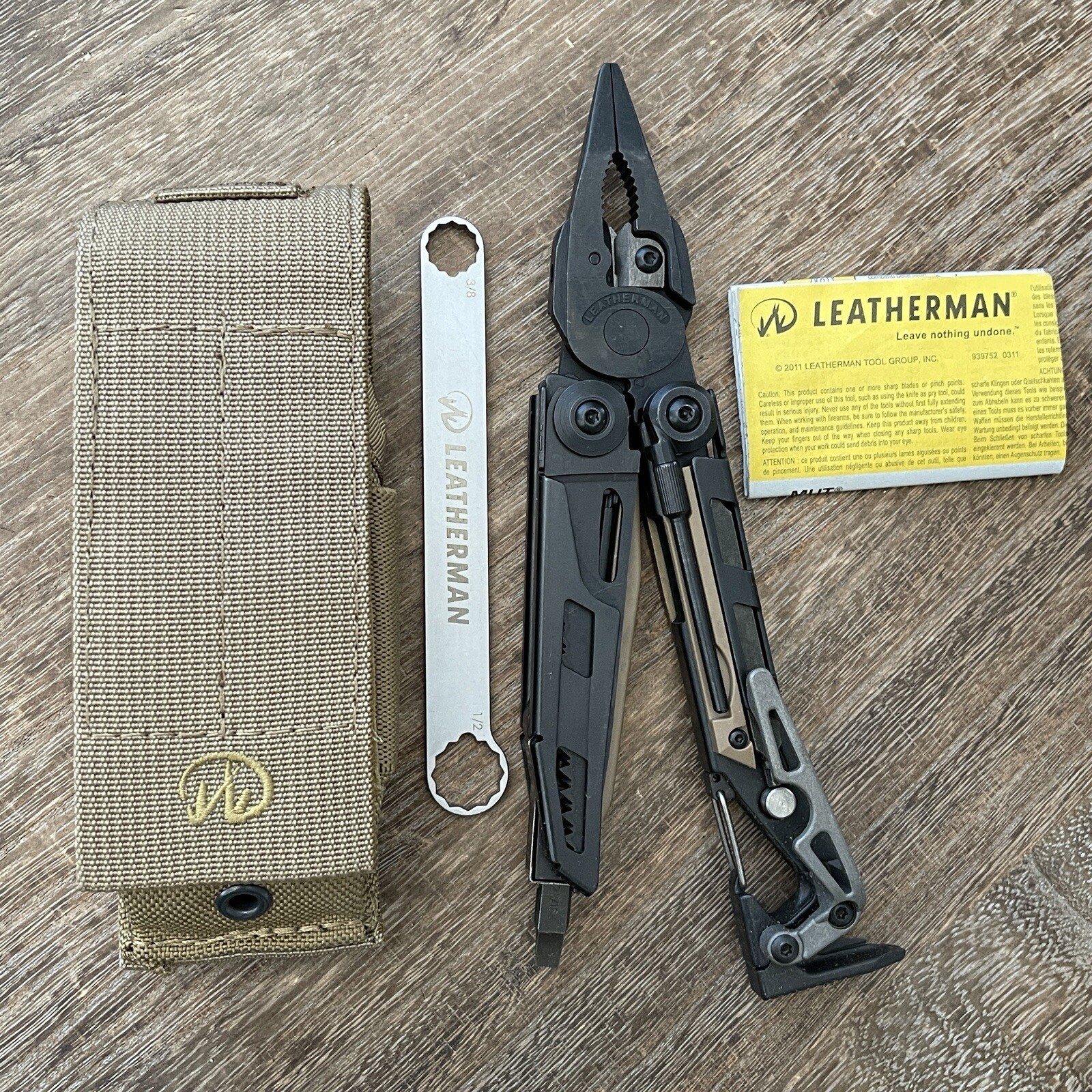 Leatherman MUT Black w/Titanium Clip multi tool, brown sheath. Made 12/2012