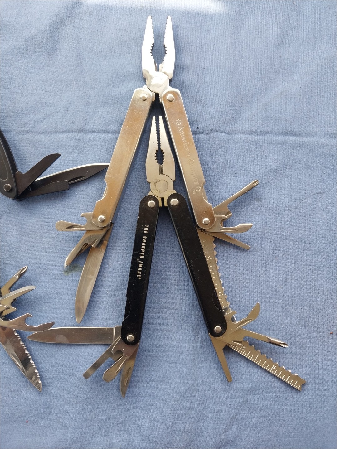 4 multi tools with pliers knives screwdrivers saw