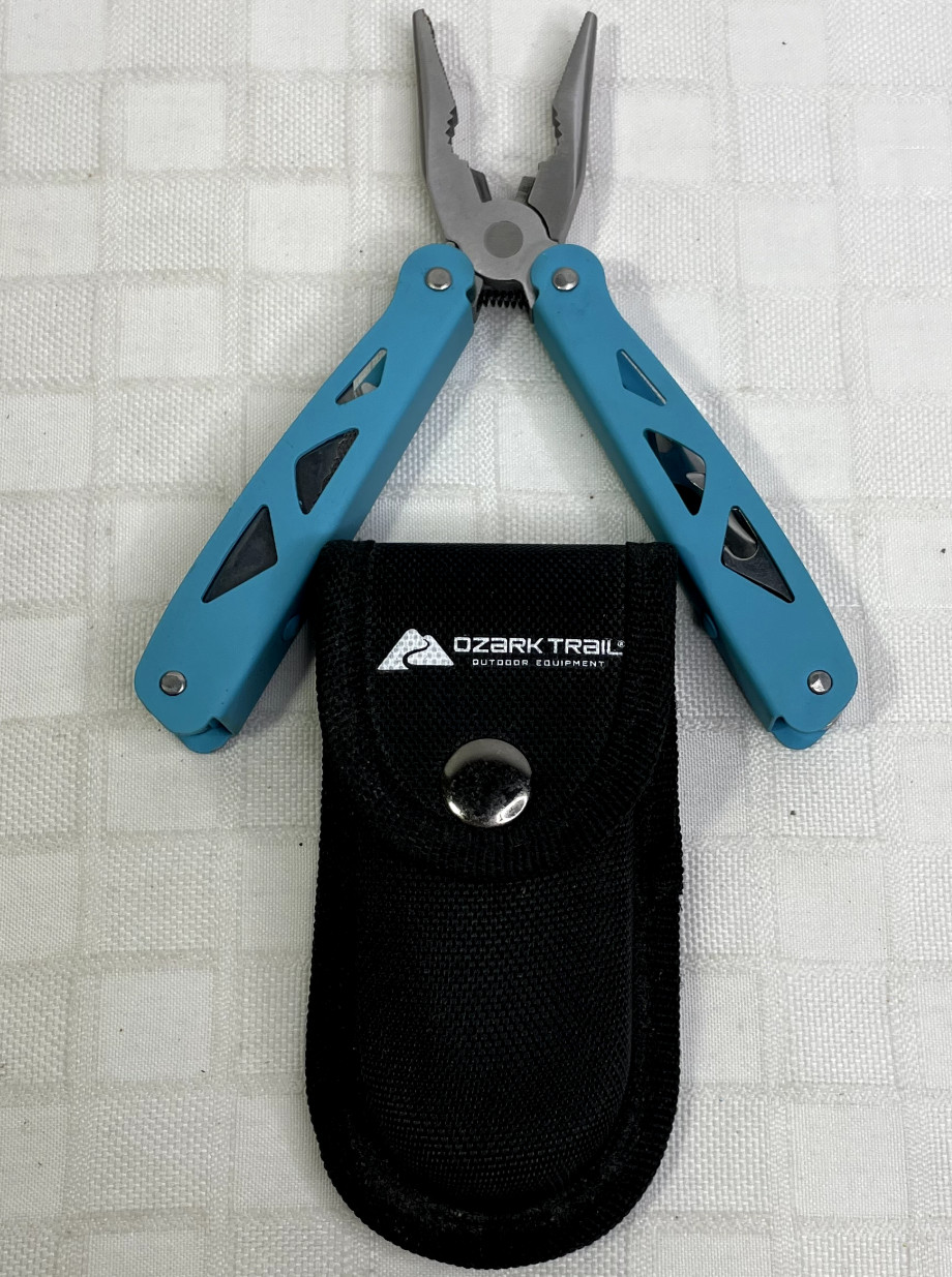 Ozark Trail 12-in-1 Multi Tool with Nylon Black Sheath Teal Blue handle.