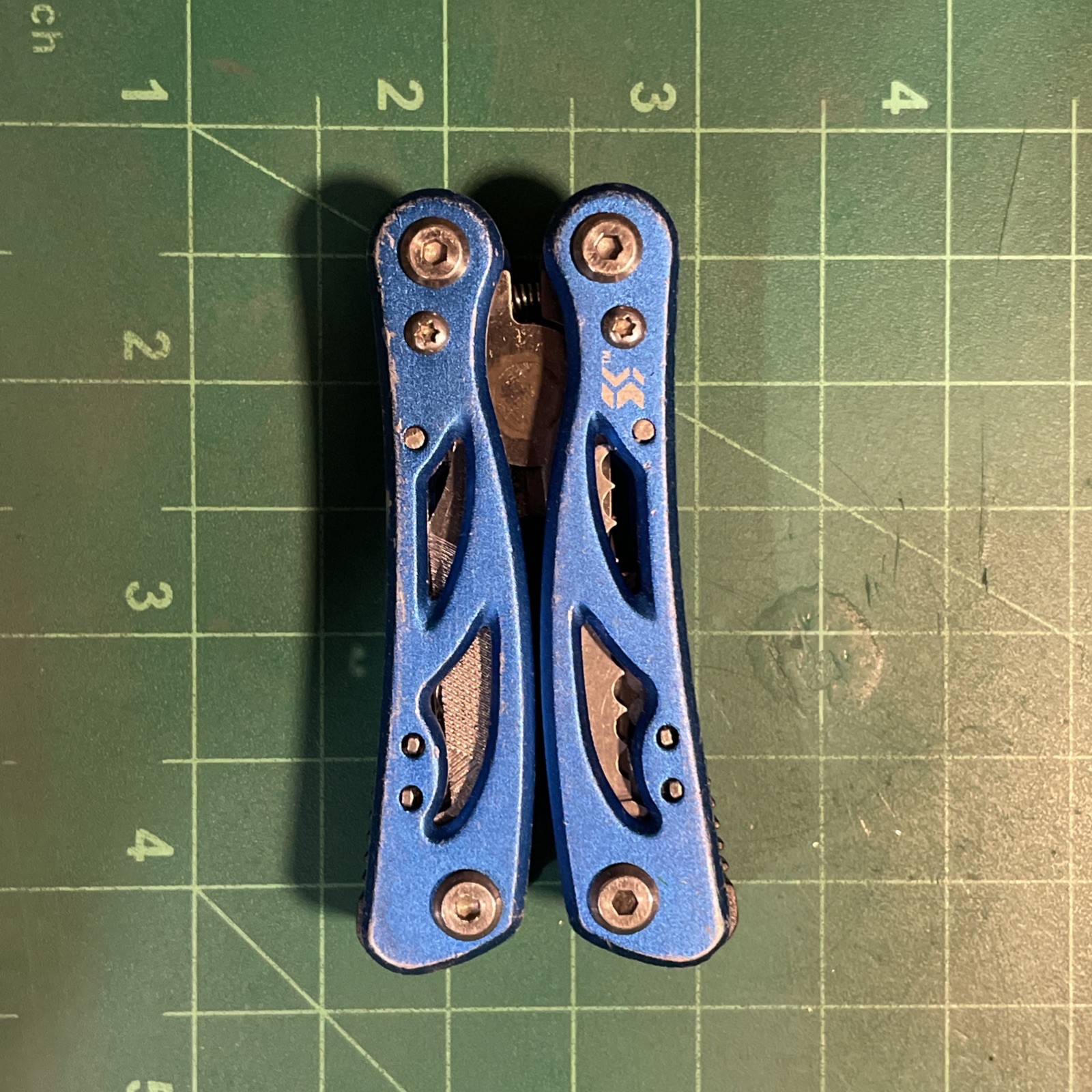 Blue Mini Multi Tool = pliers, knife, wire cutter, screwdrivers, files, etc.