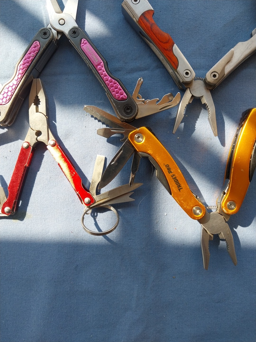 4 multi tools with pliers knives screwdrivers saw