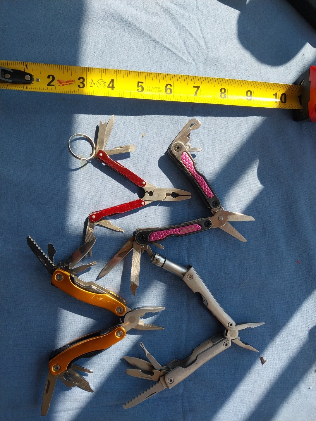 4 multi tools with pliers knives screwdrivers saw