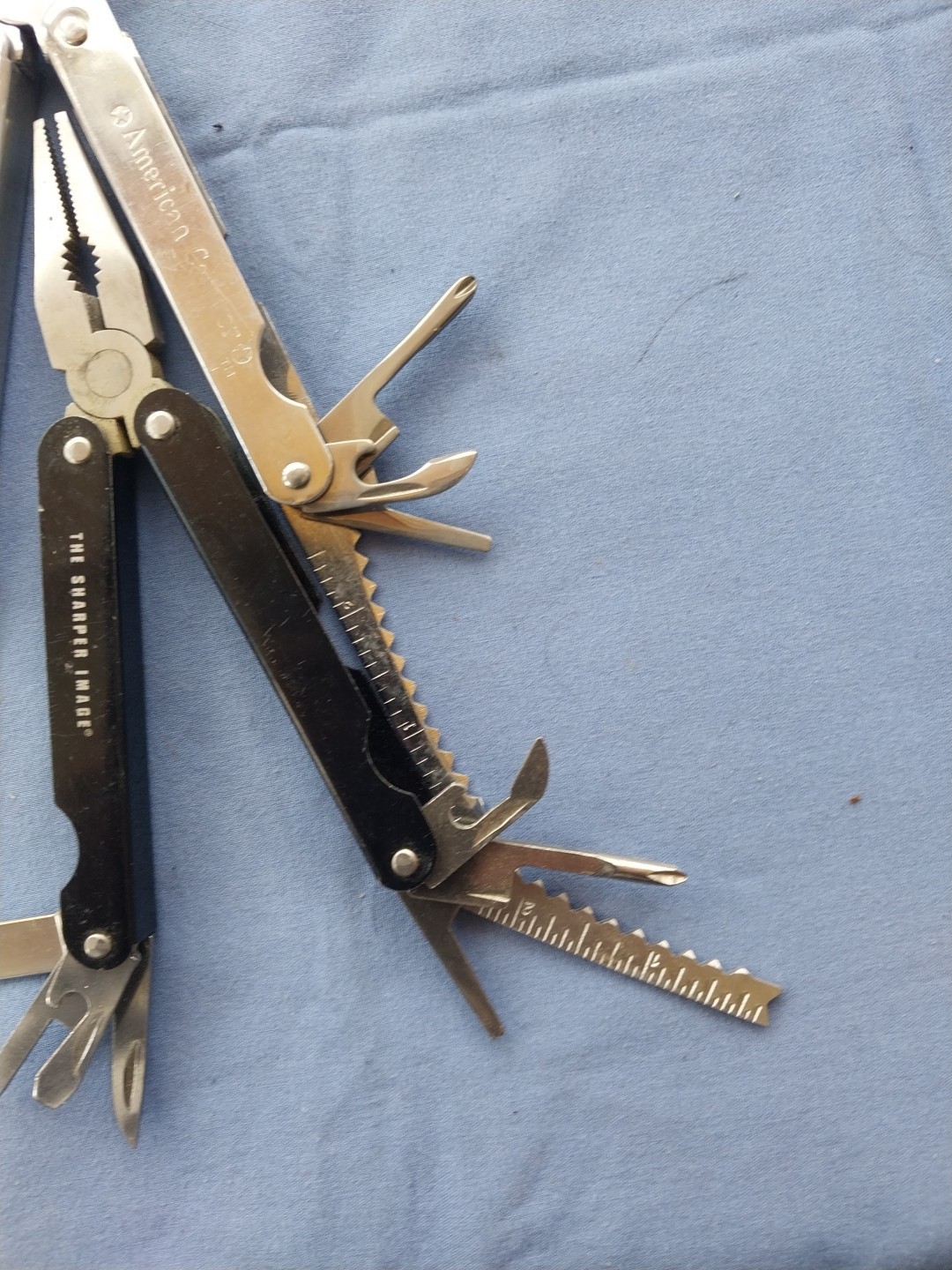 4 multi tools with pliers knives screwdrivers saw
