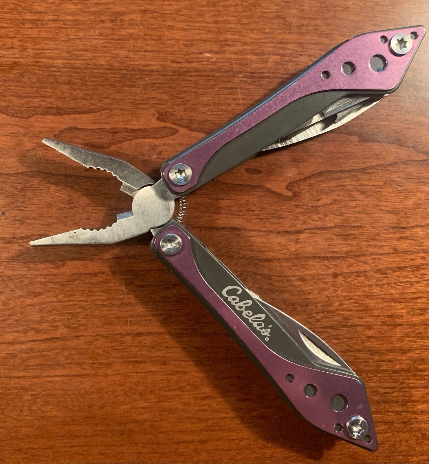 Cabela’s 8-Tool Multi-Tool with Spring Open Pliers, Scissors, Saw Purple
