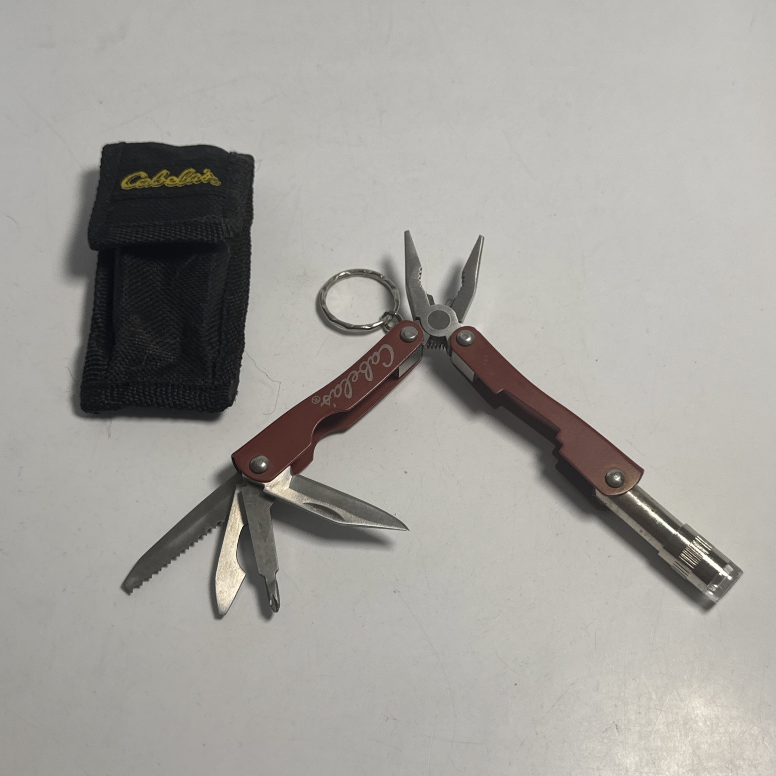 Cabelas Pocket Multi-Tool Flashlight Serrated Knife Can Opener Key chain Pliers