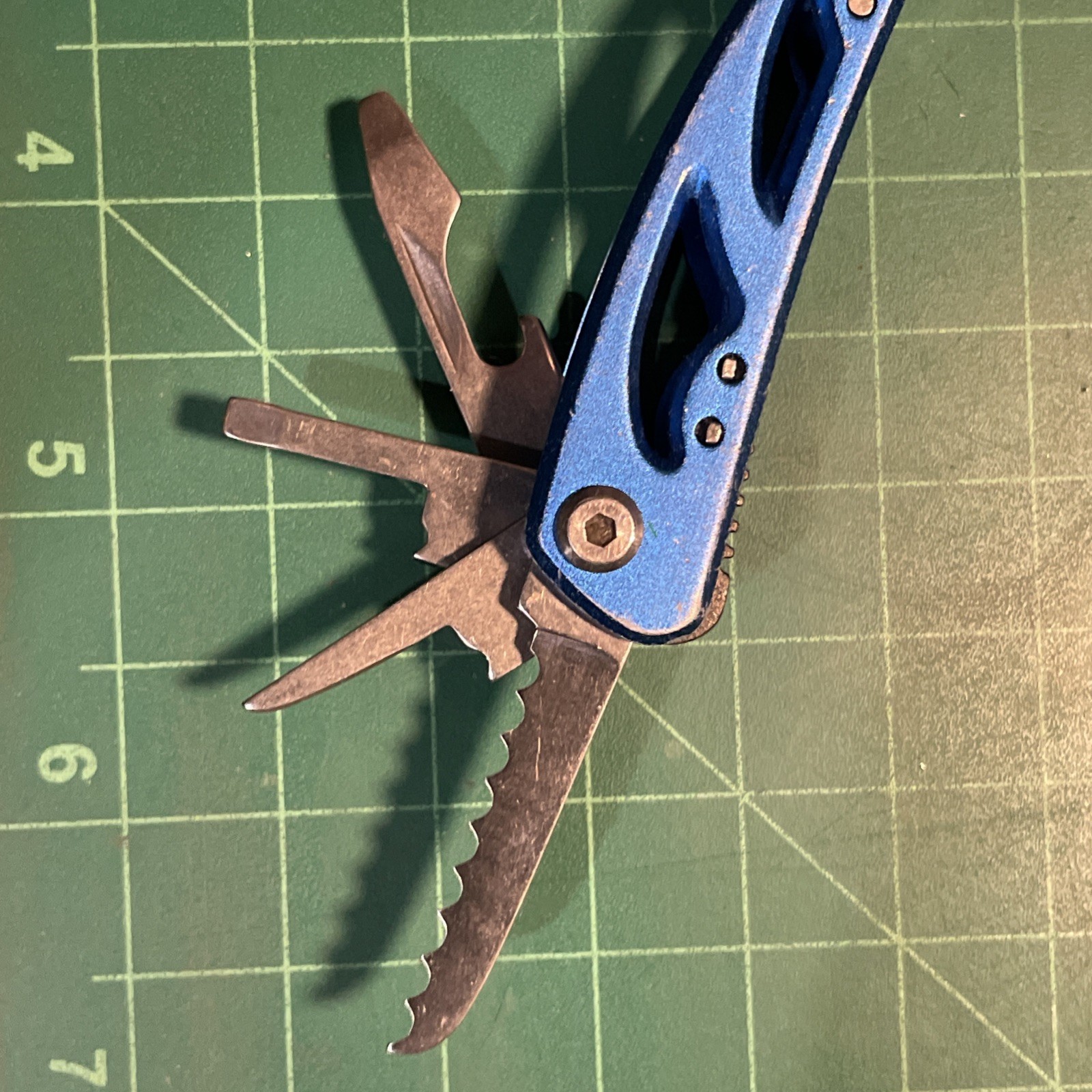Blue Mini Multi Tool = pliers, knife, wire cutter, screwdrivers, files, etc.