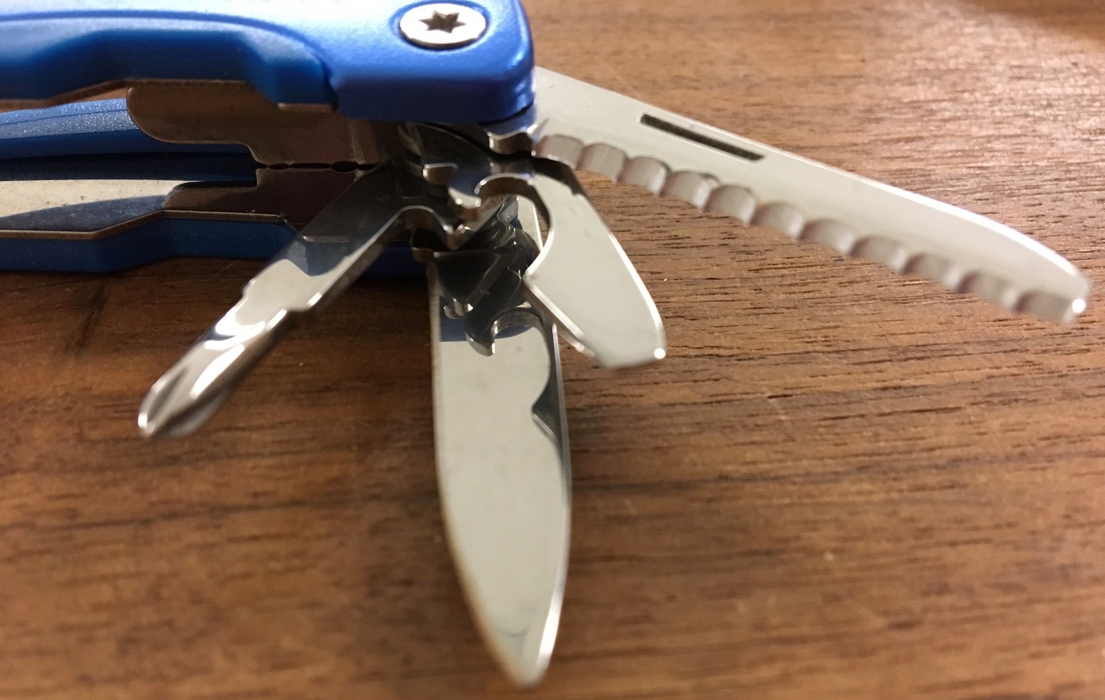 Pair of multi tools, one blue, the other black, with sheaths. Camp, hunt, crafts
