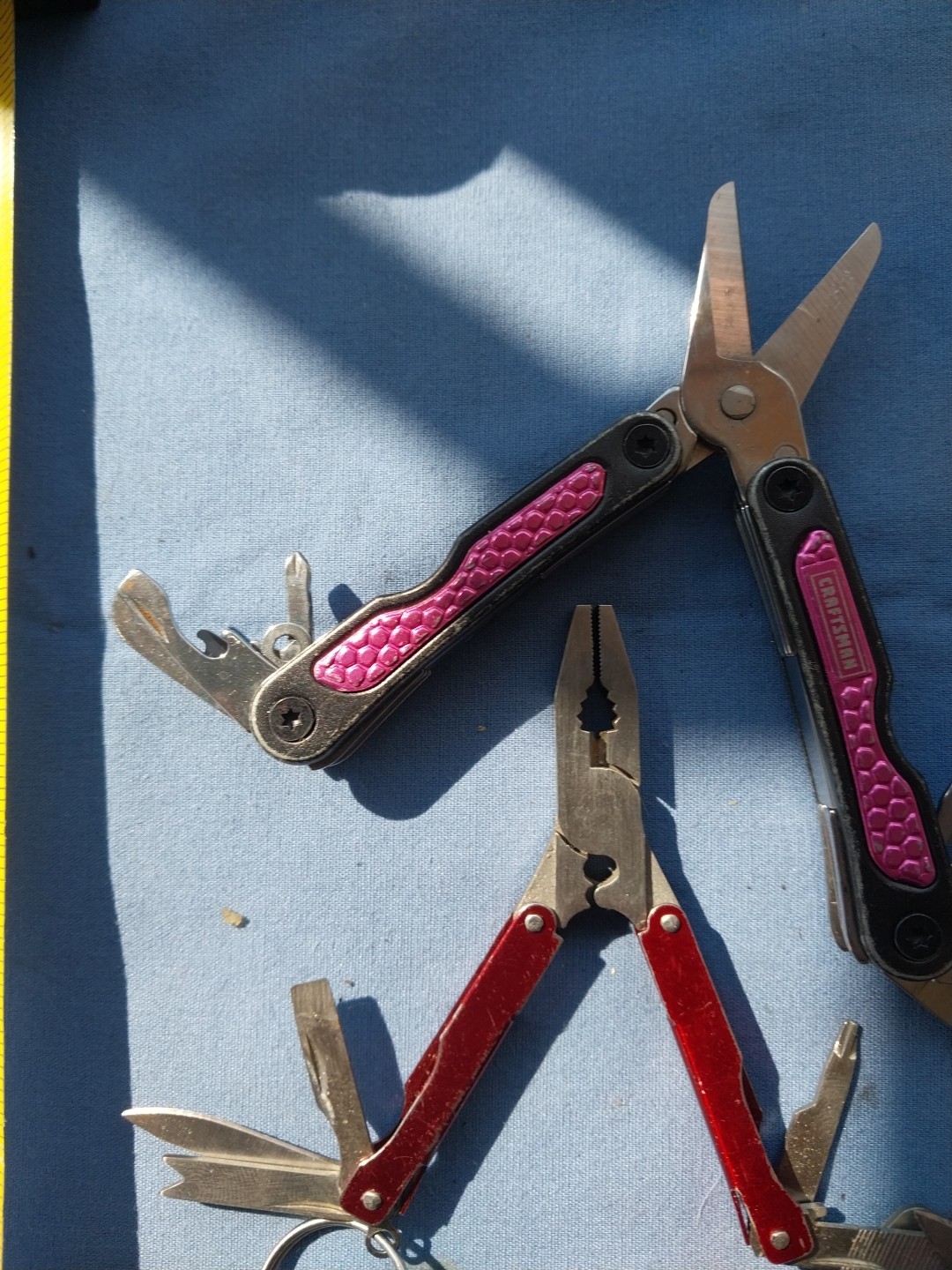 4 multi tools with pliers knives screwdrivers saw