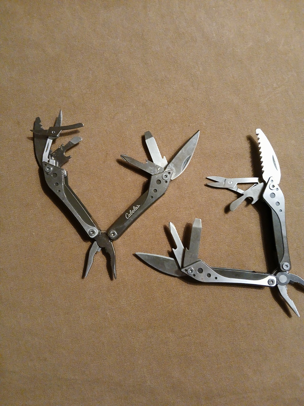 2) Cabela’s Multi-tool with nylon case unused