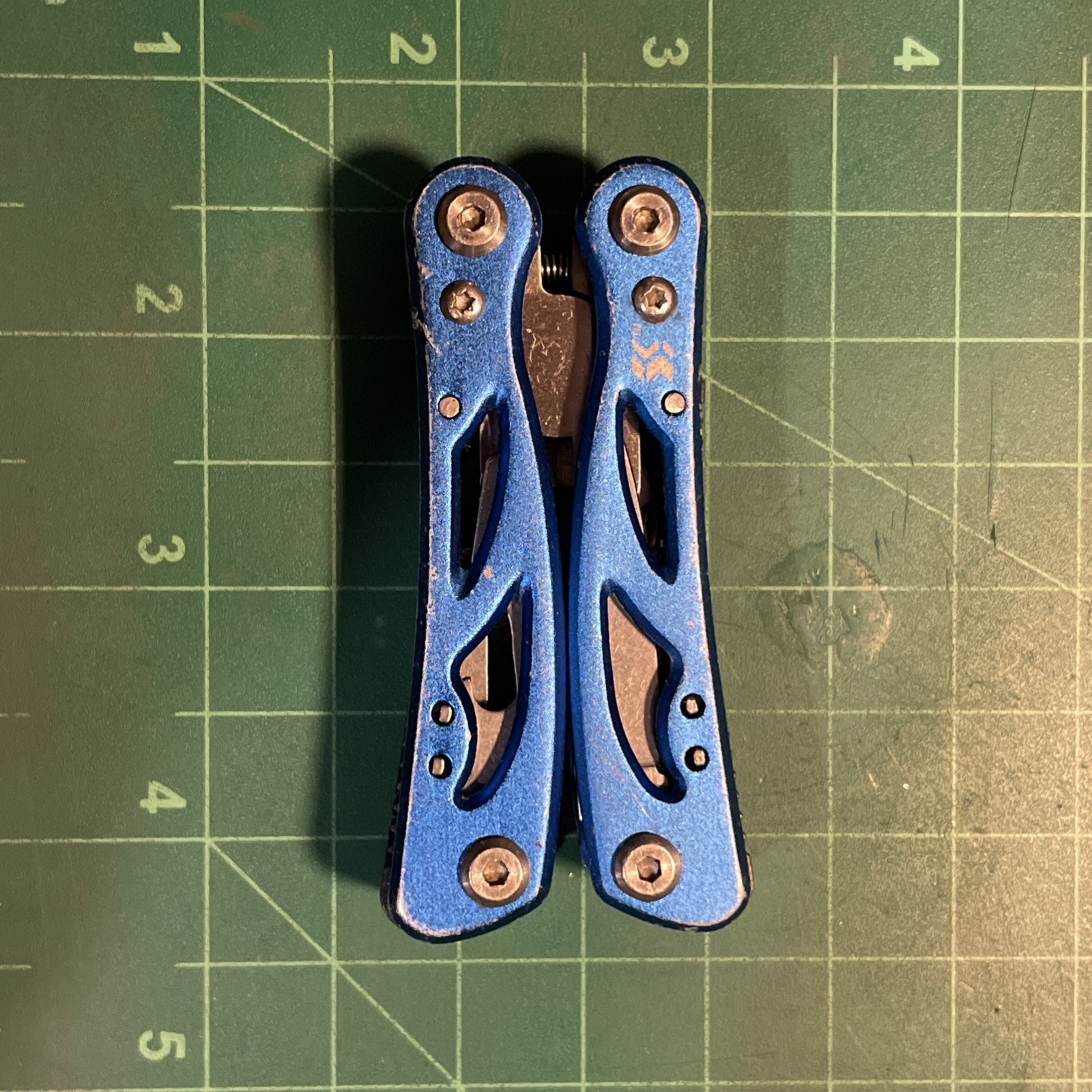 Blue Mini Multi Tool = pliers, knife, wire cutter, screwdrivers, files, etc.