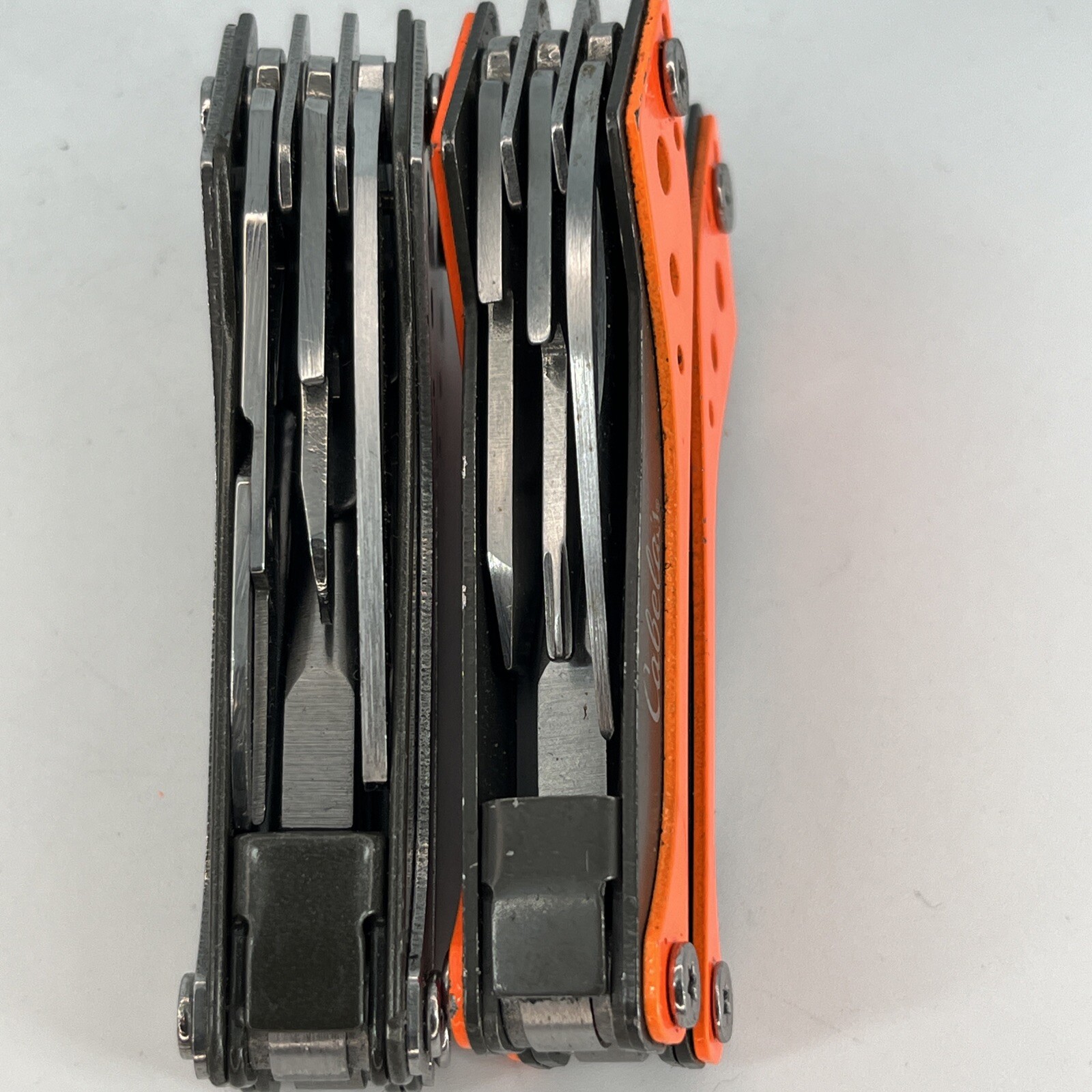 LOT OF 2 Cabela’s SILVER & ORANGE Mini MultiTool Spring Open Pliers Scissors Saw