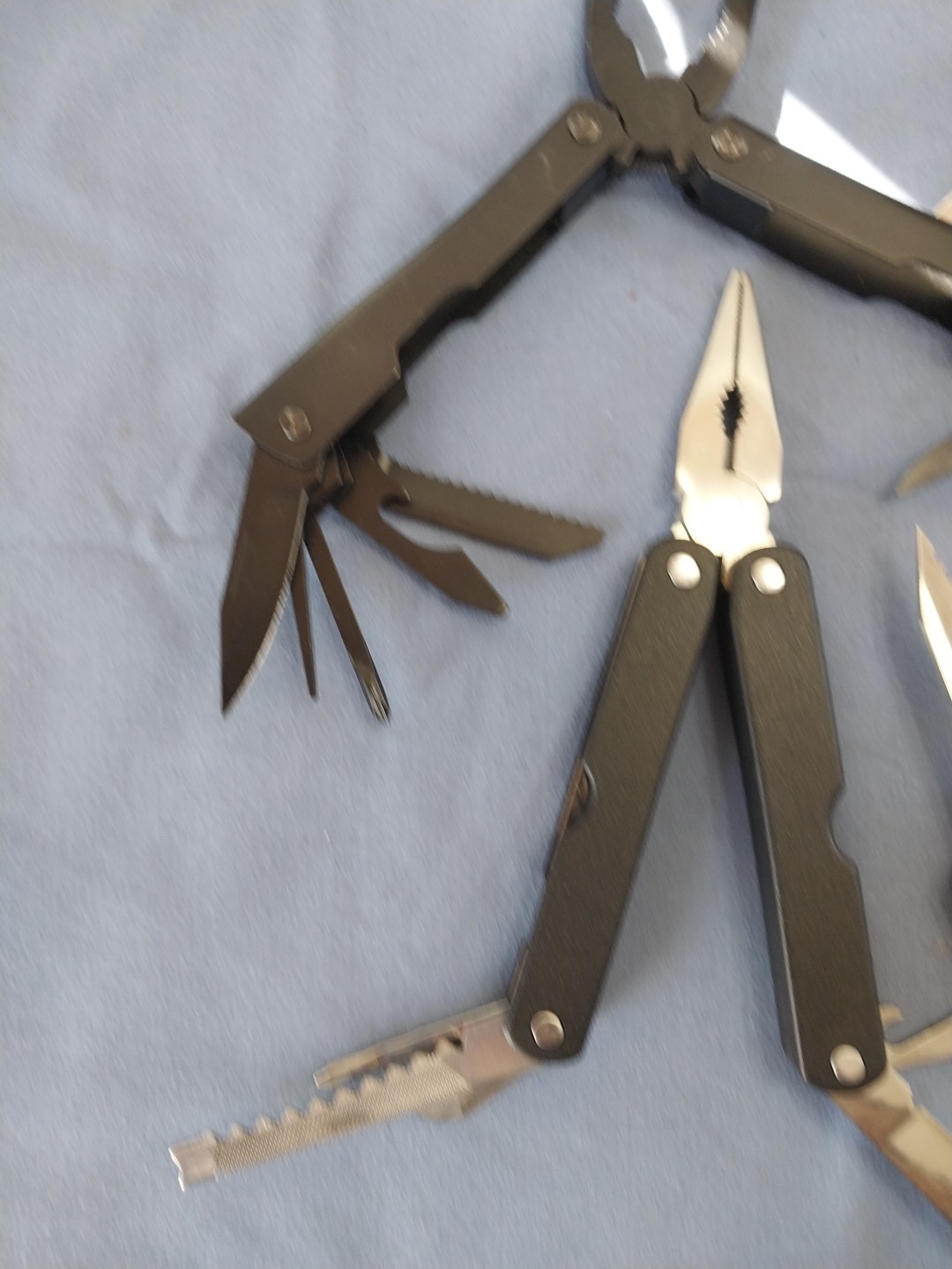 4 multi tools pliers screwdriver knife saw