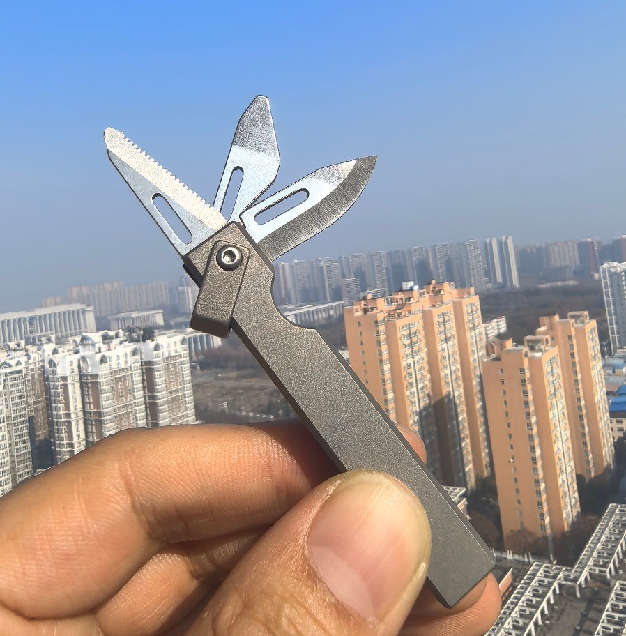 4-in-1 Compact Titanium Survival Tool Keychain with Saw Whistle and Pry Bar
