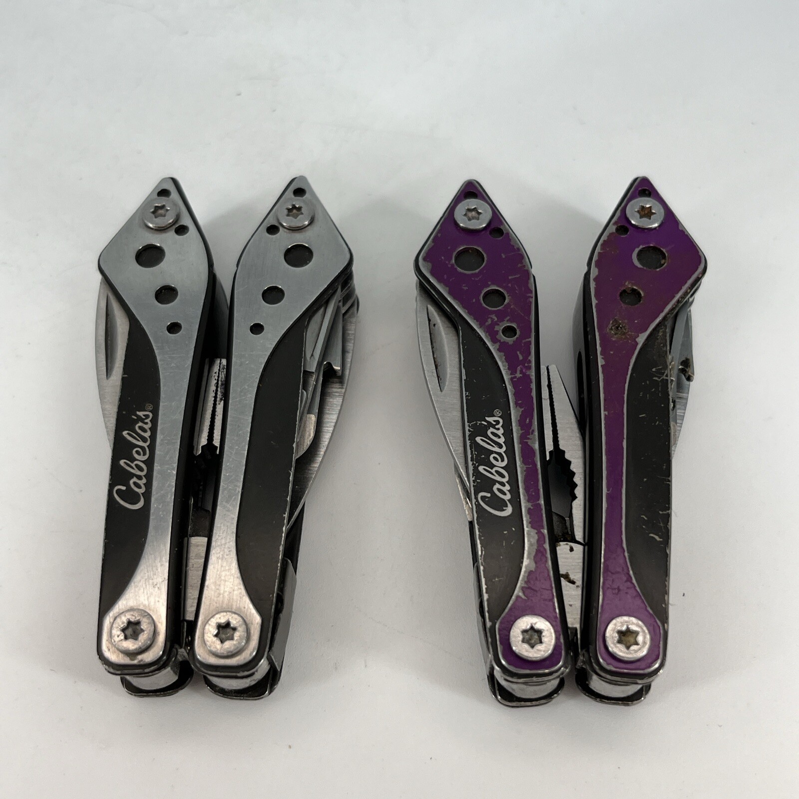 LOT OF 2 Cabela’s PURPLE & SILVER Mini MultiTool Spring Open Pliers Scissors Saw
