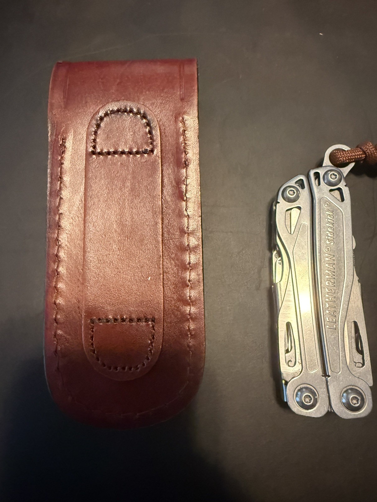 leatherman sidekick multi tool. With old timer genuine leather case. Lanyard
